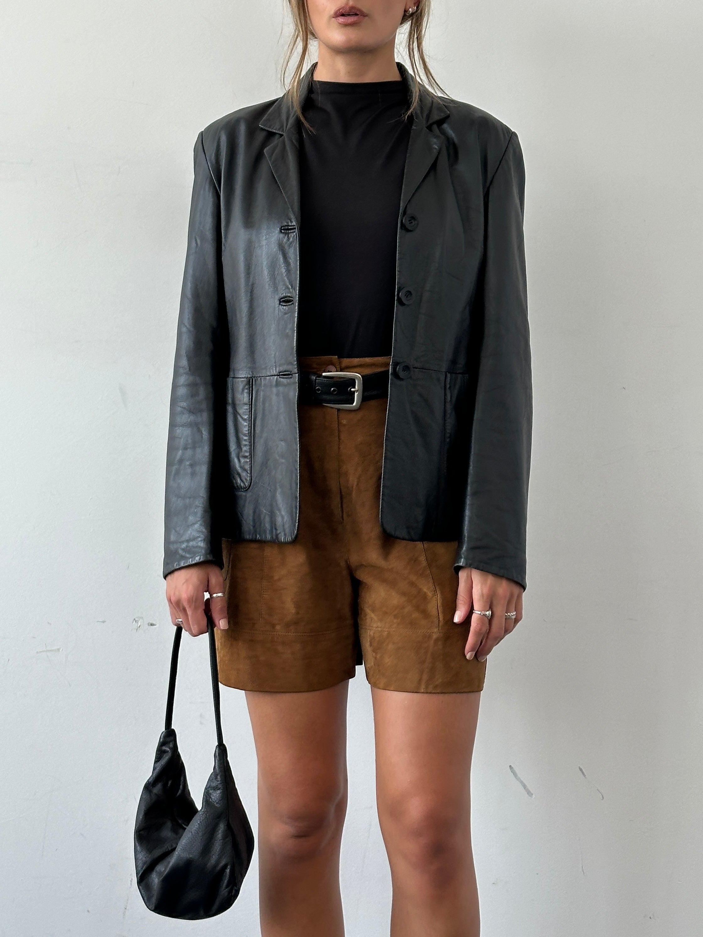 Vintage fitted leather blazer jacket, size small, featuring classic design and smooth leather texture.