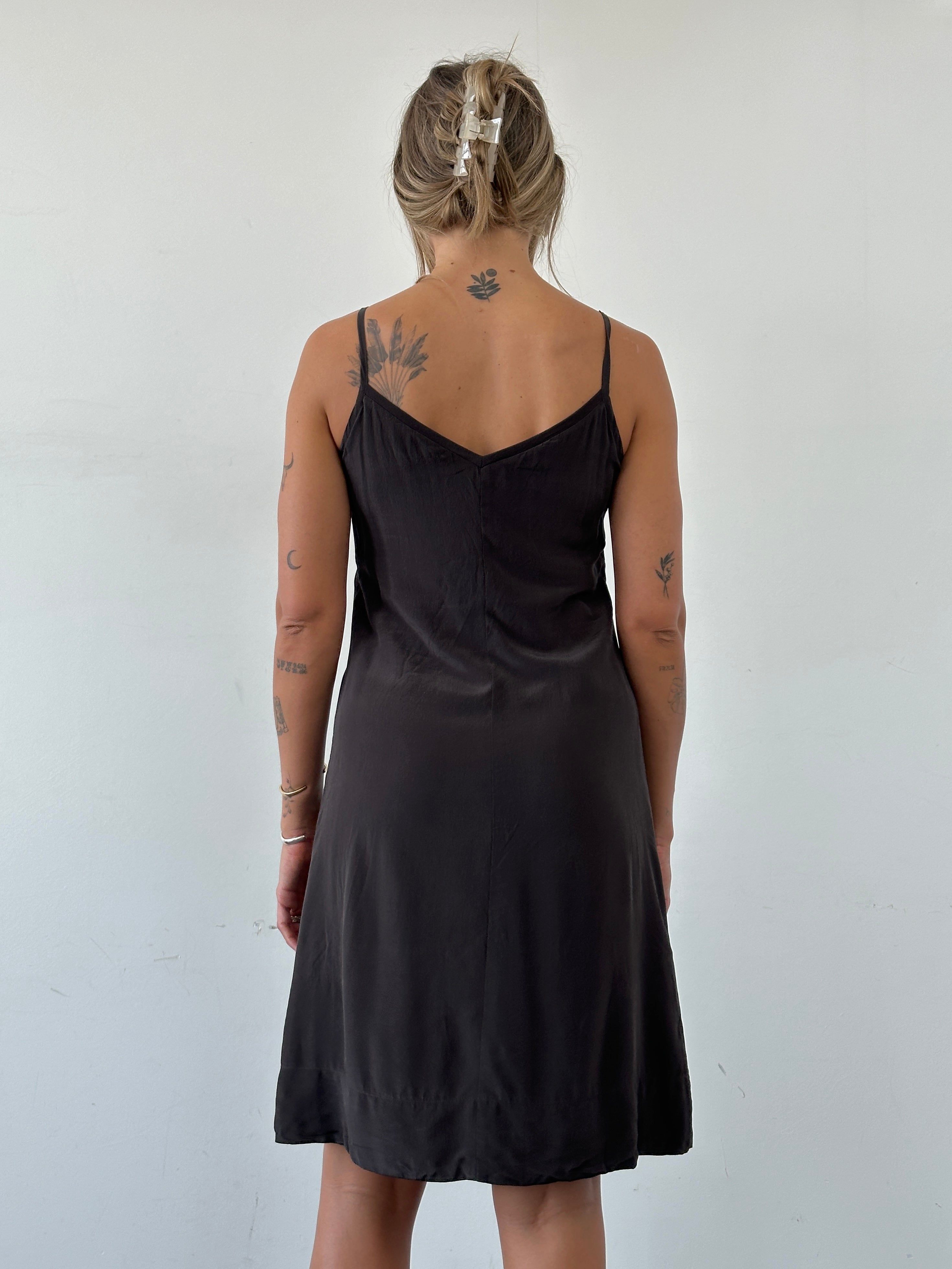 Max Mara S pure silk slip dress displayed on a hanger, showcasing smooth fabric and elegant design.