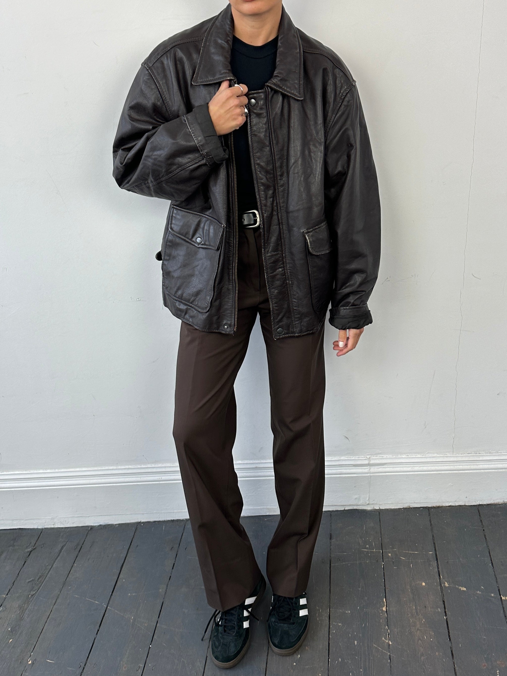 Vintage minimal zip-up leather jacket in XL, showcasing sleek design and classic black leather with silver zipper details.