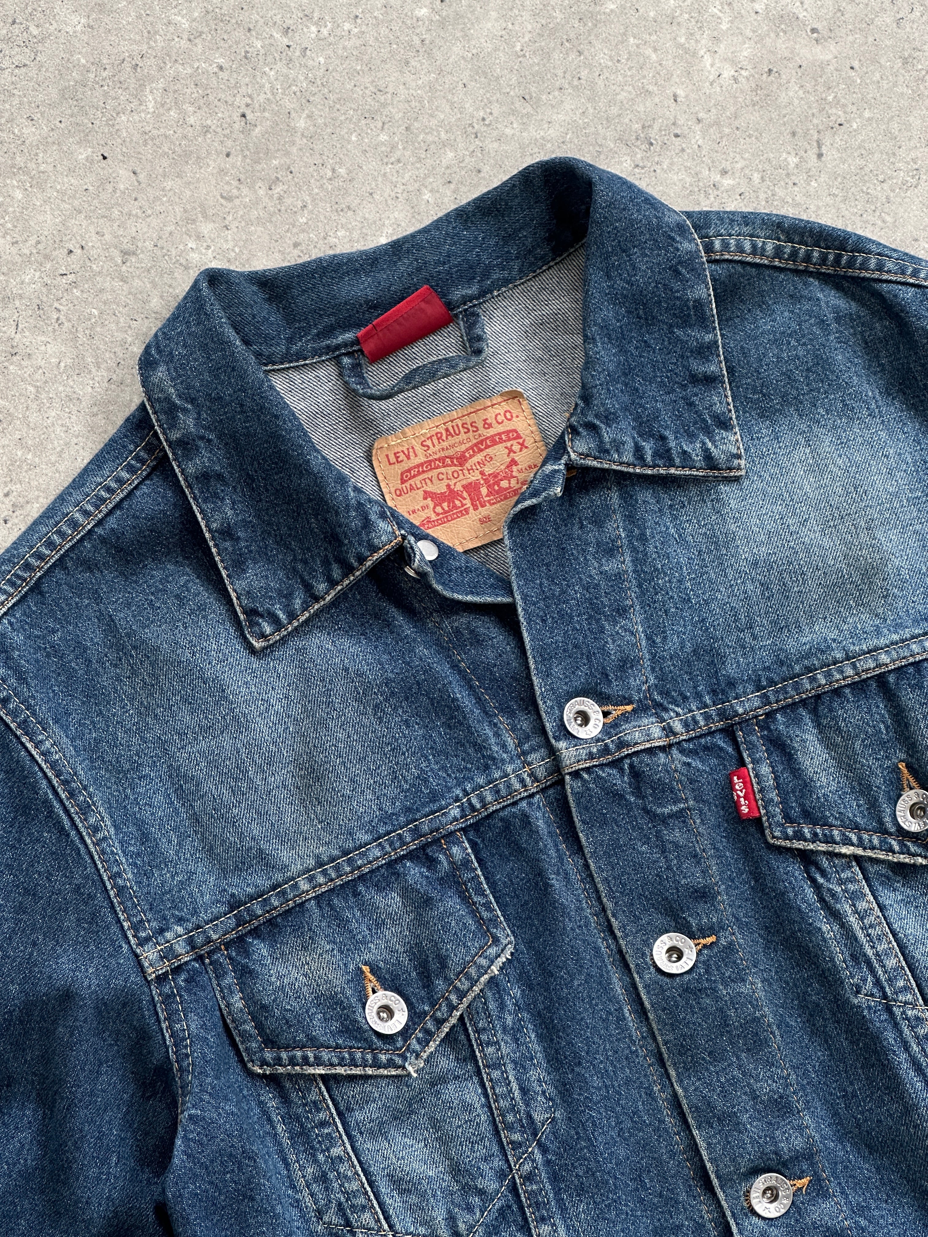 Levi’s faded denim jacket in size S, showcasing classic distressed denim with front pockets and button closure.