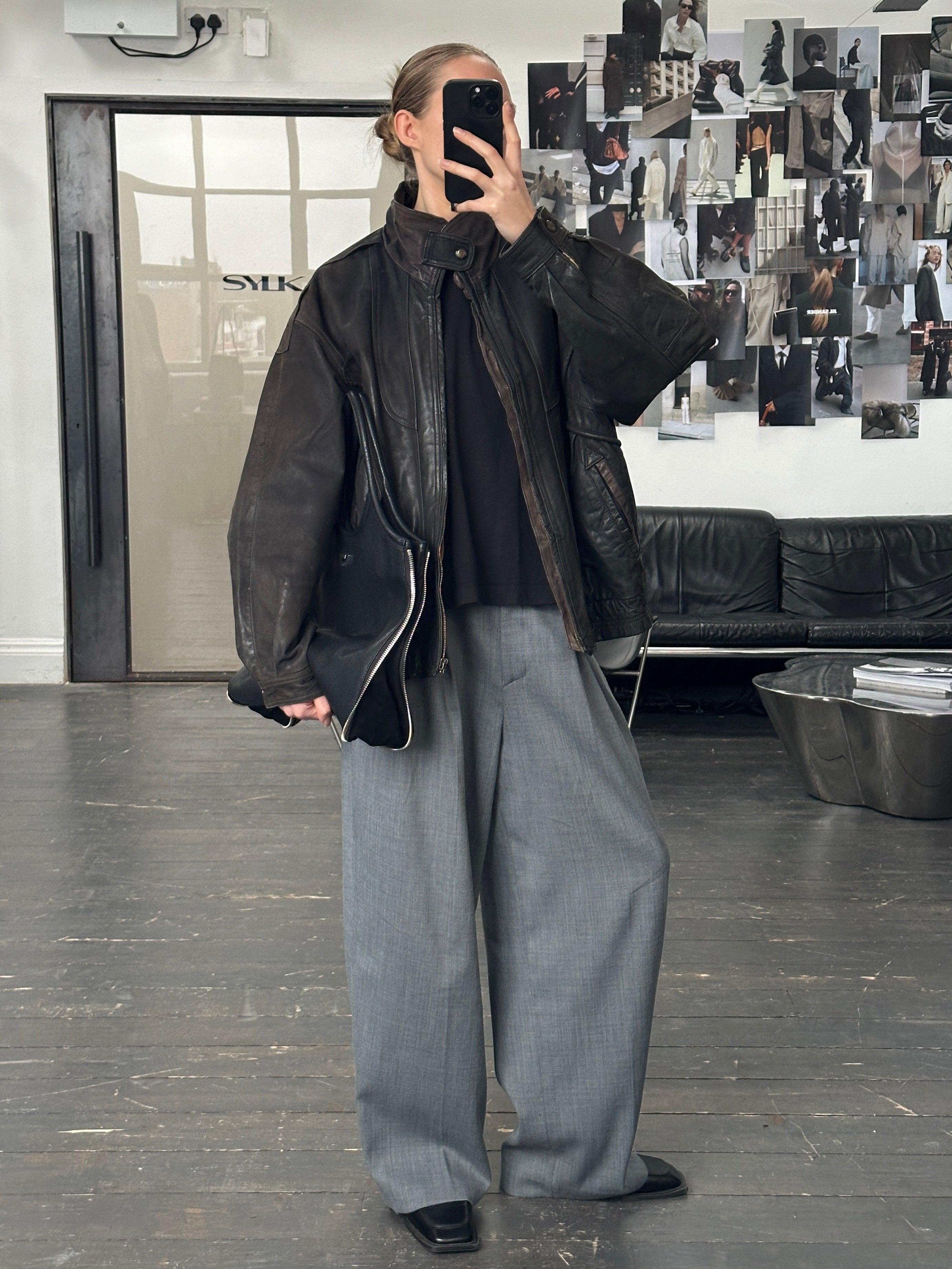 Vintage 1990s aged leather bomber jacket in XL, featuring distressed leather and classic bomber style.