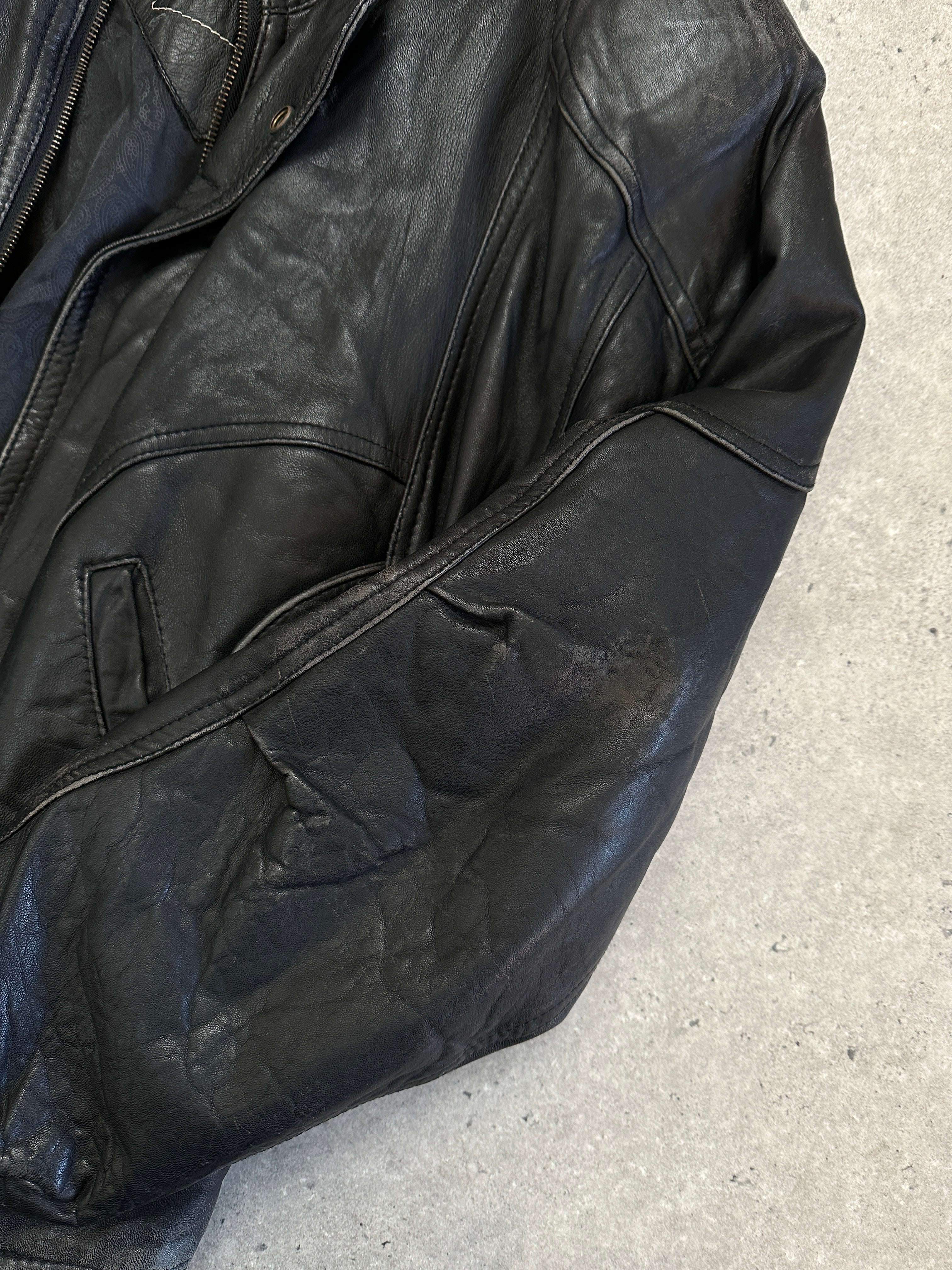 Vintage leather bomber jacket in size M, featuring classic style and brown leather material, displayed on a hanger.