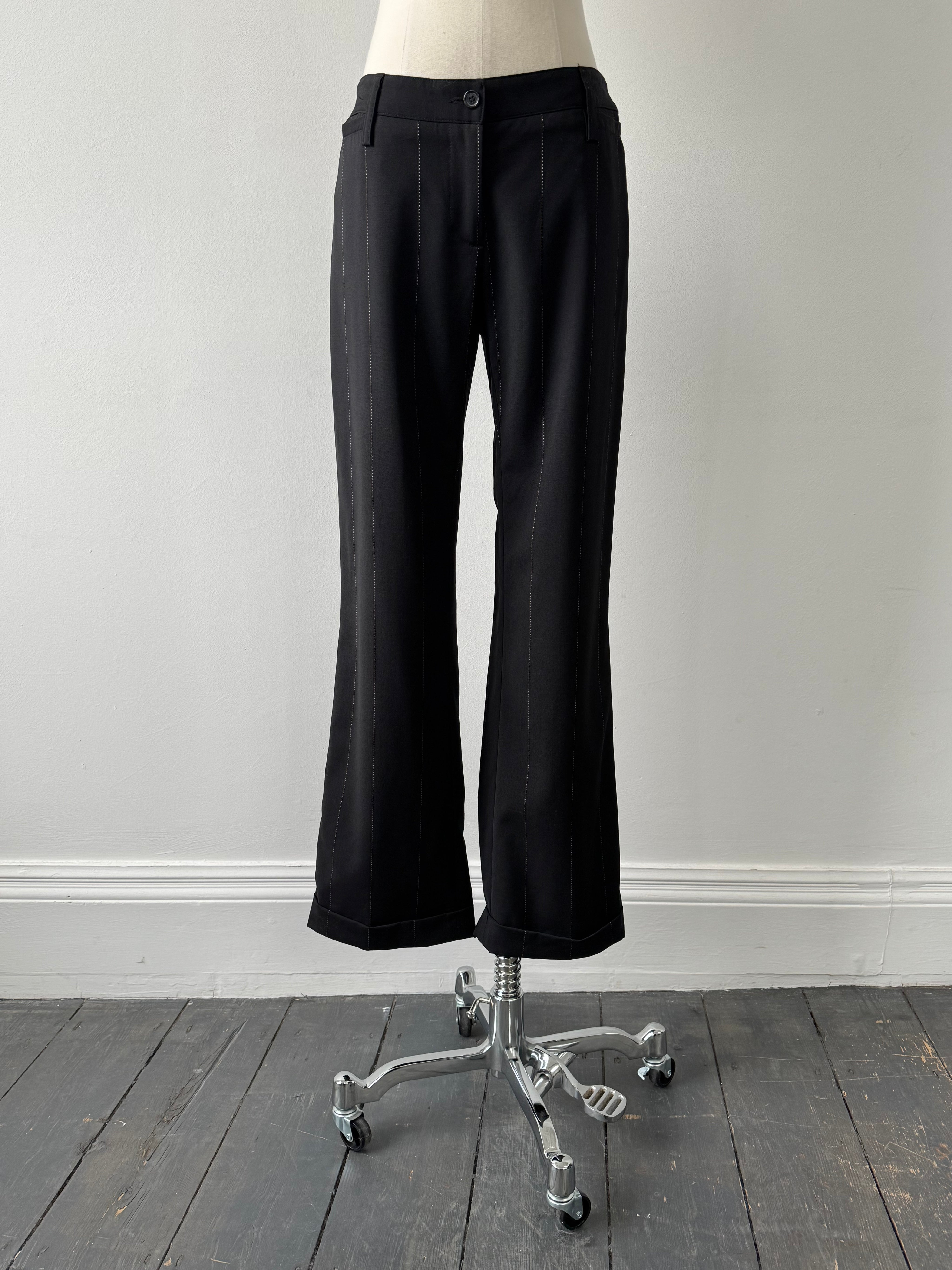 Dolce & Gabbana 2000s wool trousers in size W28, featuring classic tailored design and neutral fabric, displayed on a hanger.