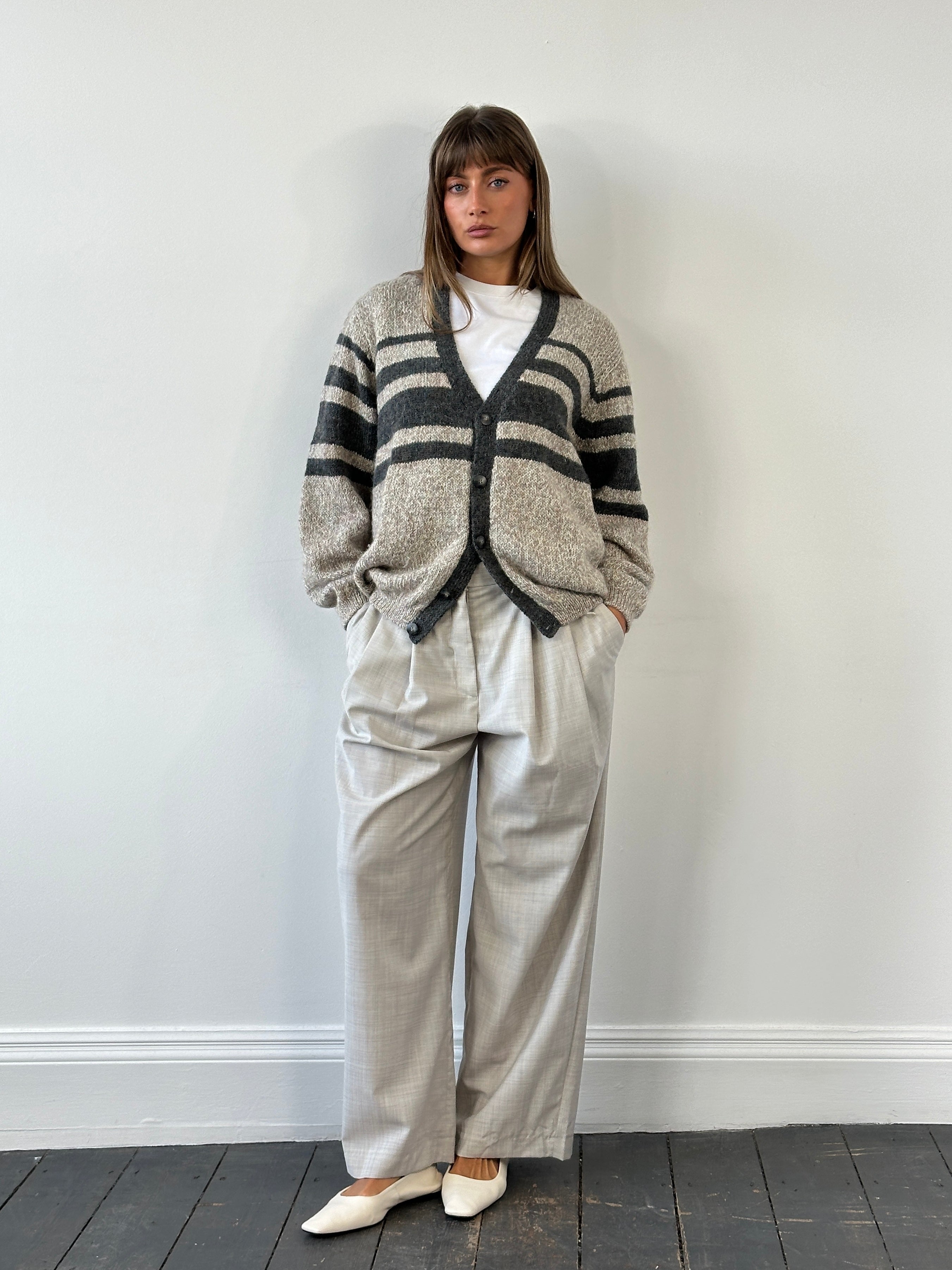 Vintage 1990s pure wool knitted stripe cardigan in size L/XL, featuring colorful horizontal stripes and a cozy, classic design.
