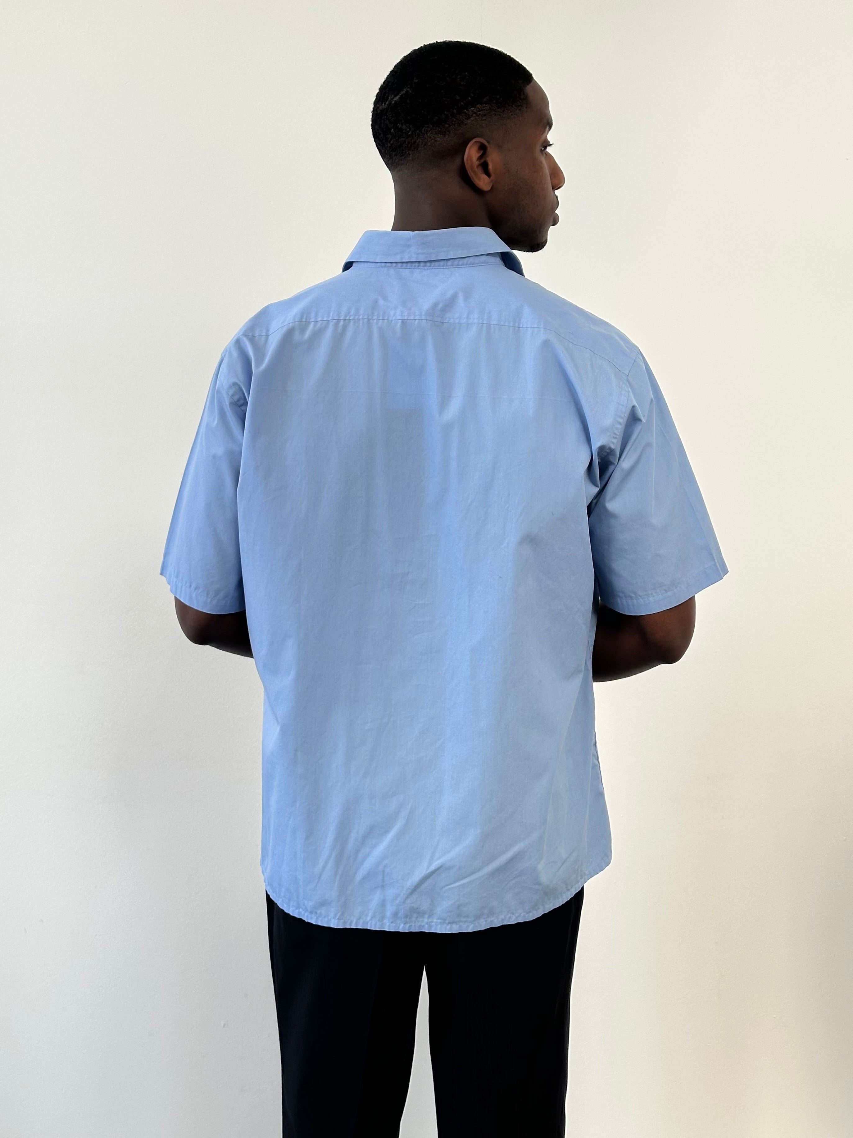 Yves Saint Laurent Pour Homme cotton short sleeve logo shirt in size L/XL, featuring a classic design and branded logo on the front.