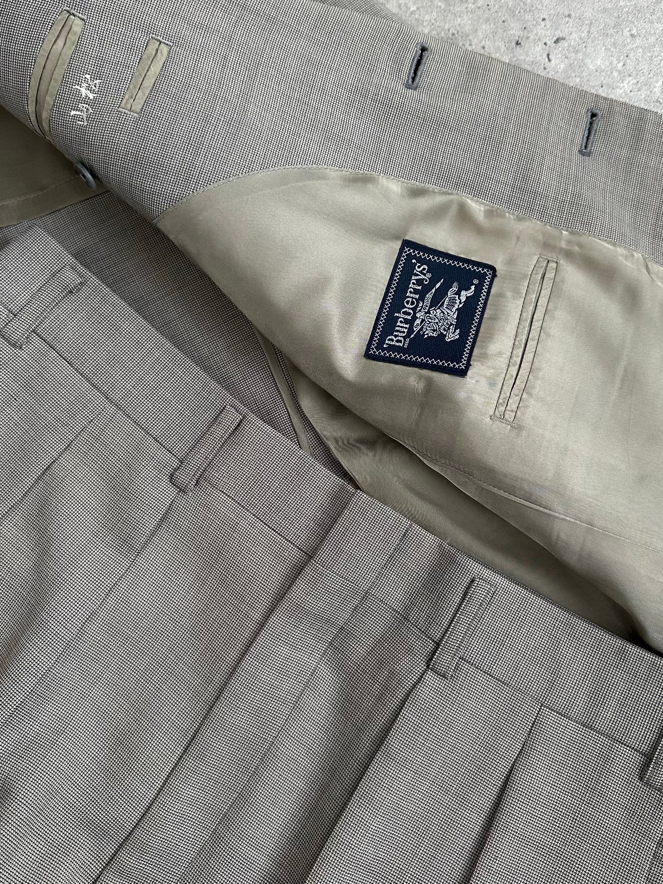 Burberry 1990s pure wool single-breasted suit, displayed on a mannequin, featuring classic tailored design and neutral color.