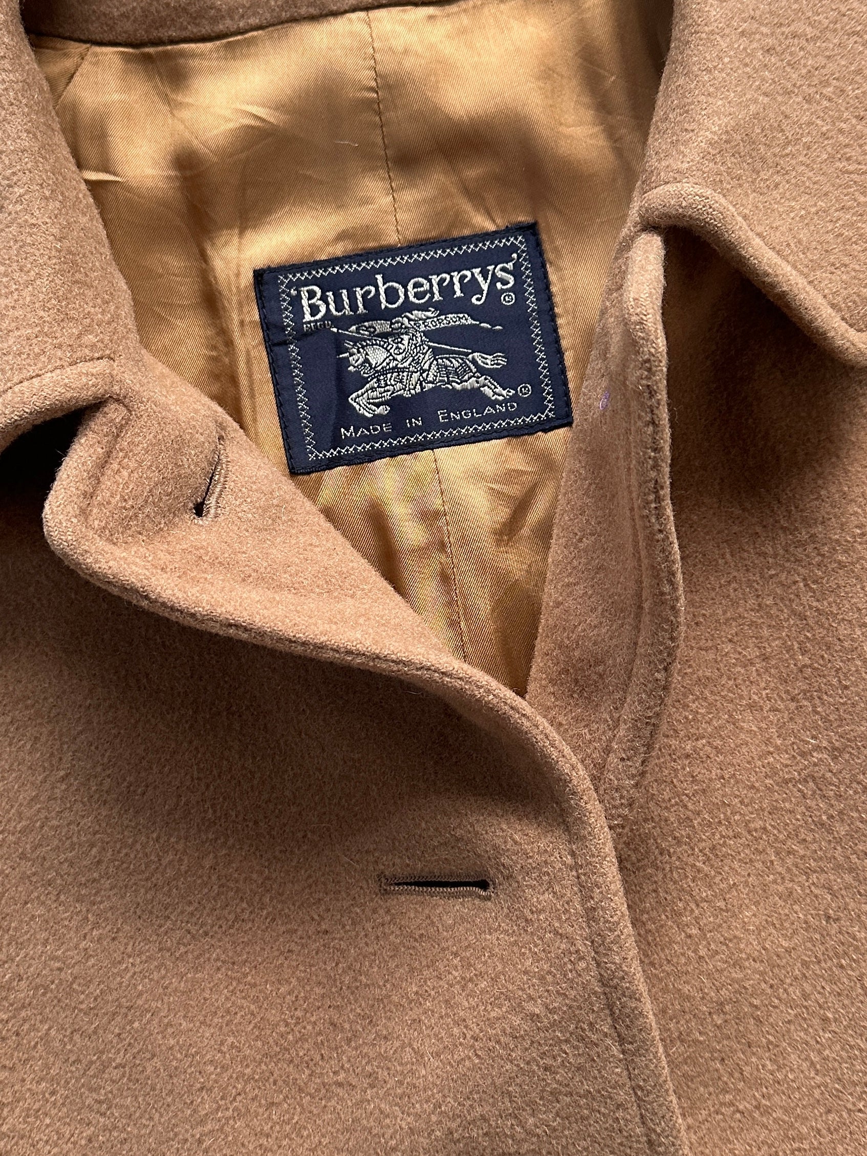 Burberry wool camel hair single-breasted coat in size L, featuring classic design and tailored fit, displayed on a neutral background.