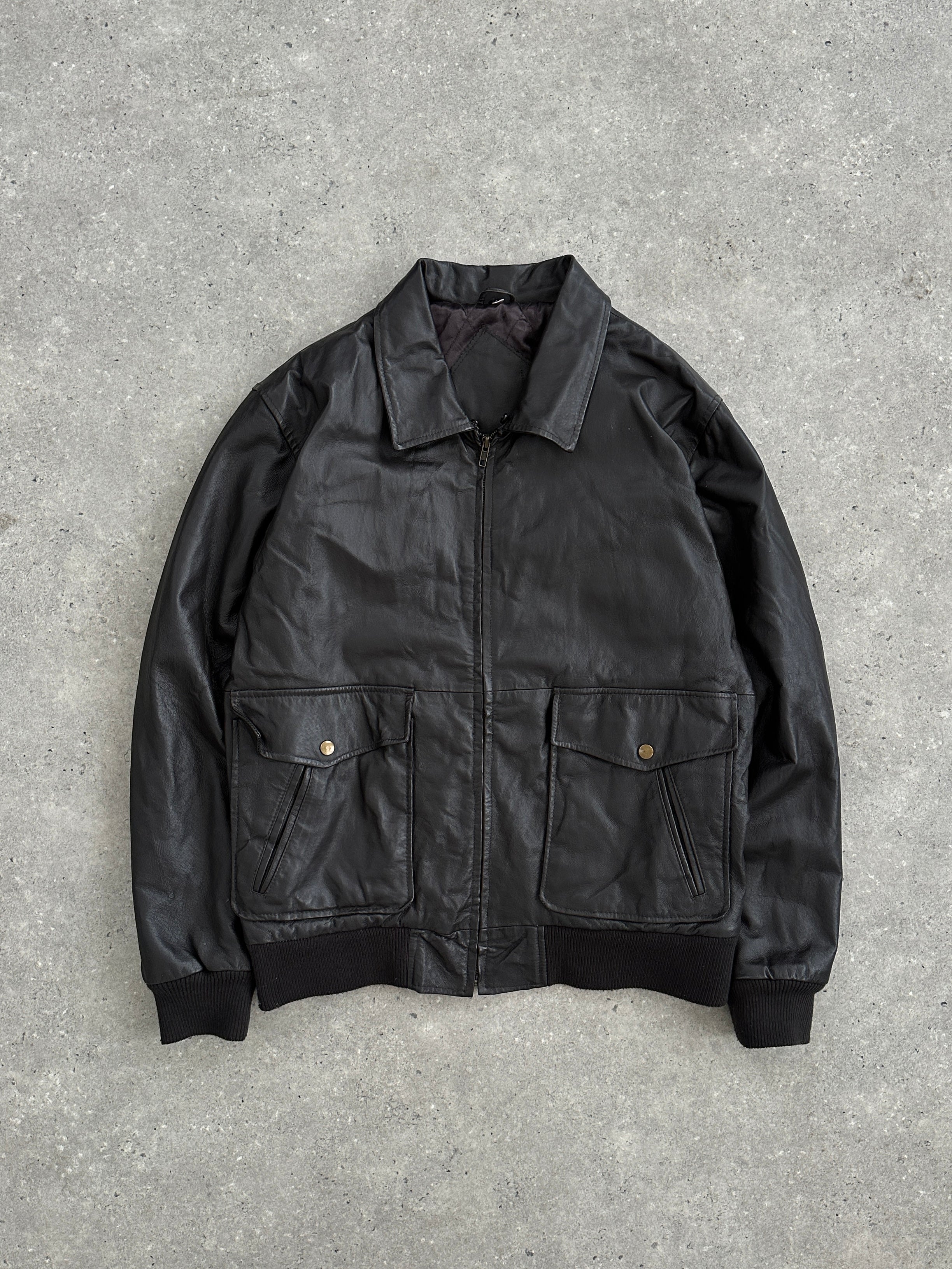 Vintage smooth leather bomber jacket in size L, featuring classic design and durable construction, displayed on a hanger.