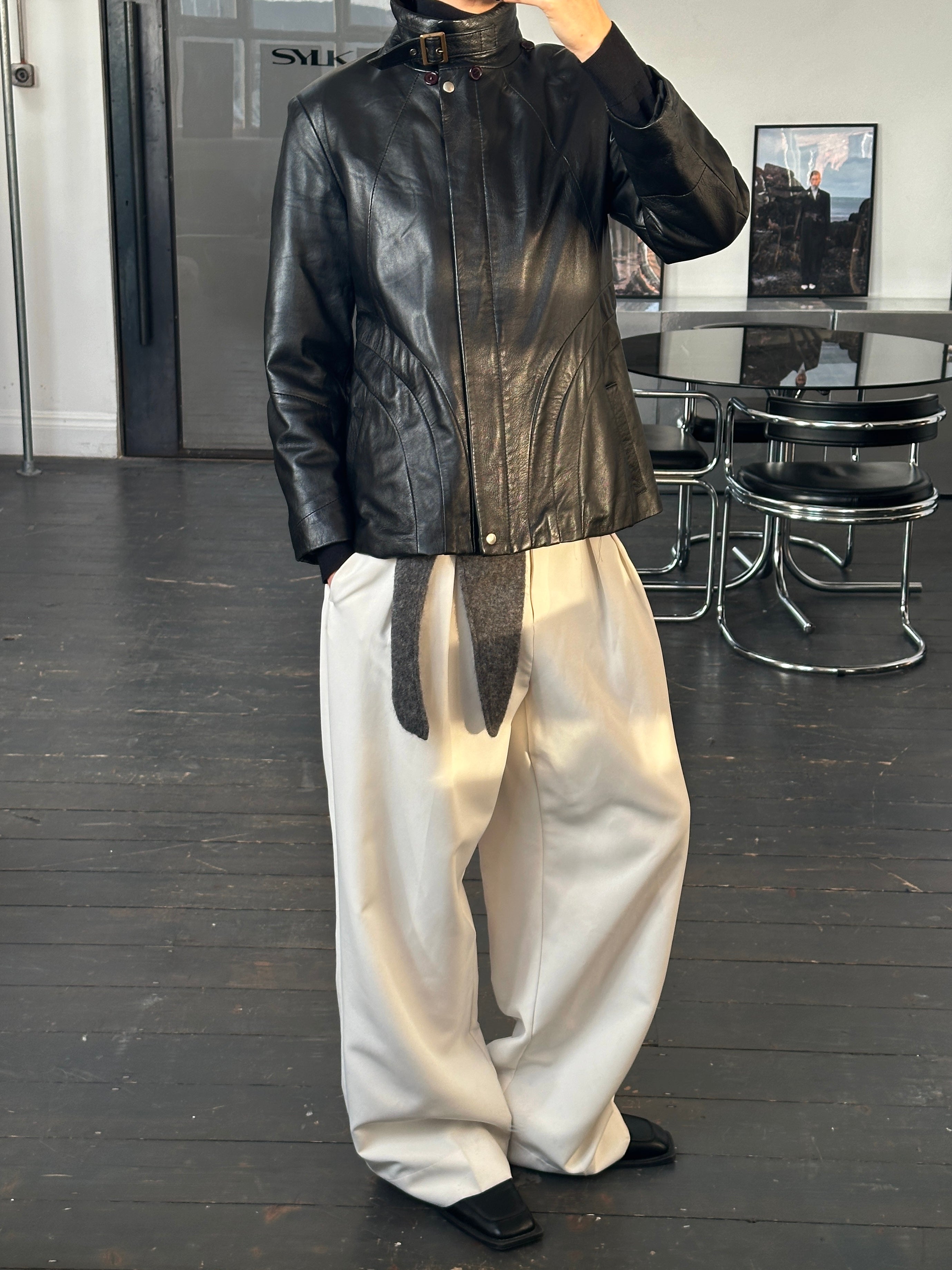 Vintage Italian 1990s high neck leather jacket in size M, featuring classic black leather and a stylish high neckline.