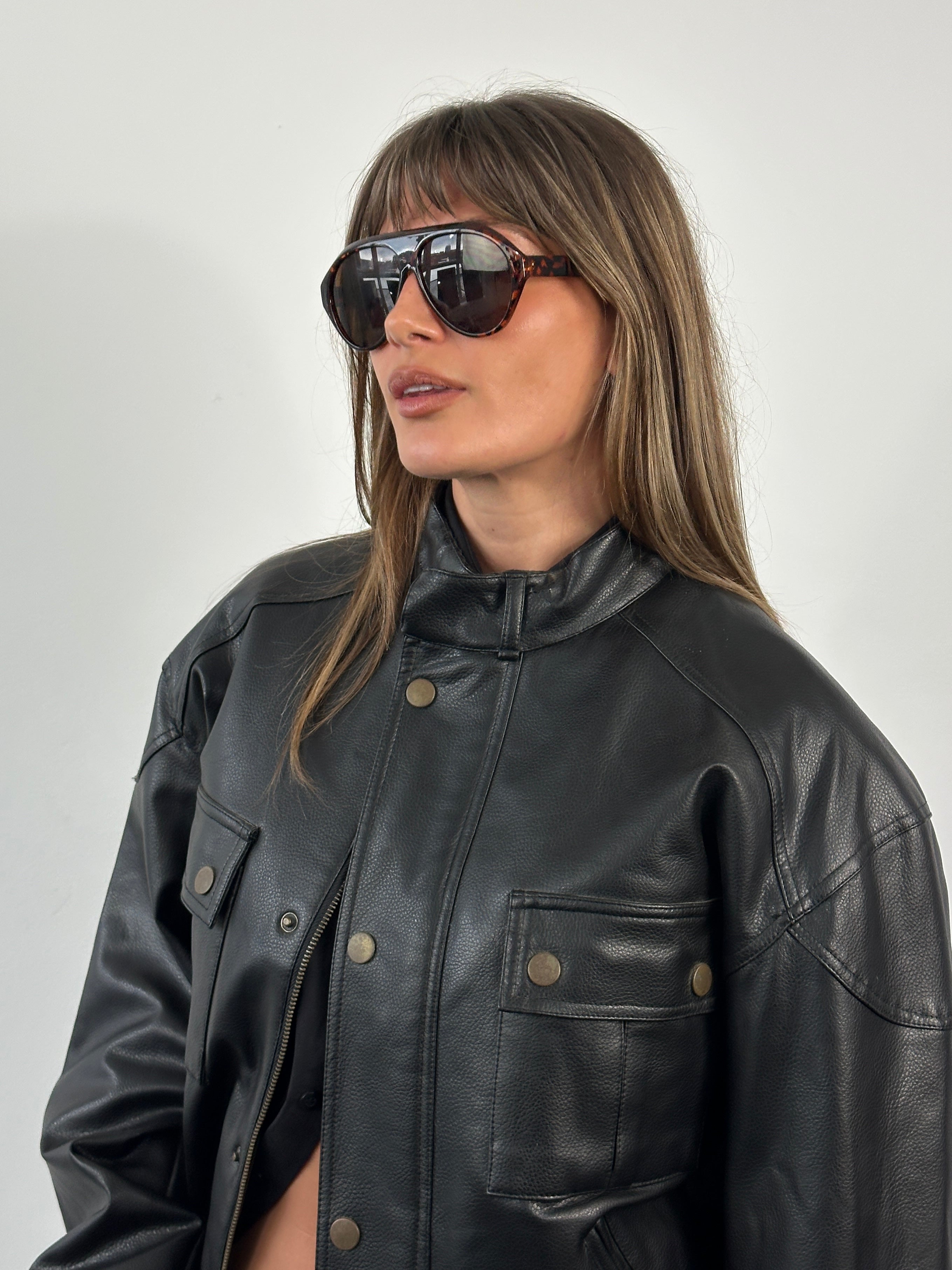 Vintage 1990s boxy faux leather jacket, size M, featuring classic design and textured black faux leather.
