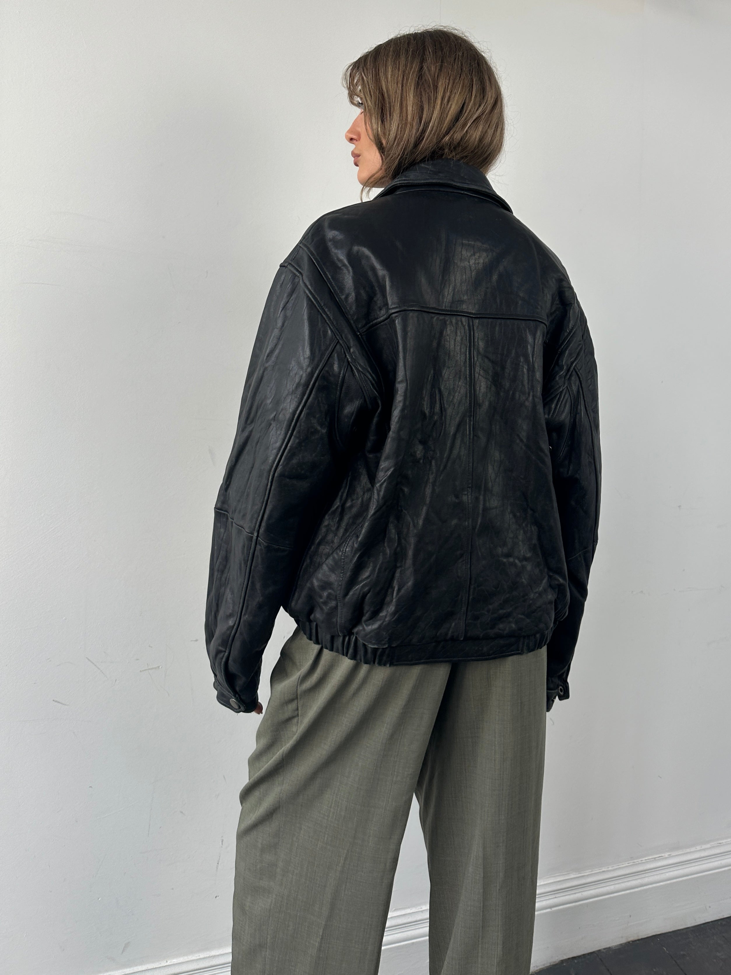 Vintage minimal soft leather bomber jacket in size M, stylish and lightweight, featuring classic design and smooth leather texture.