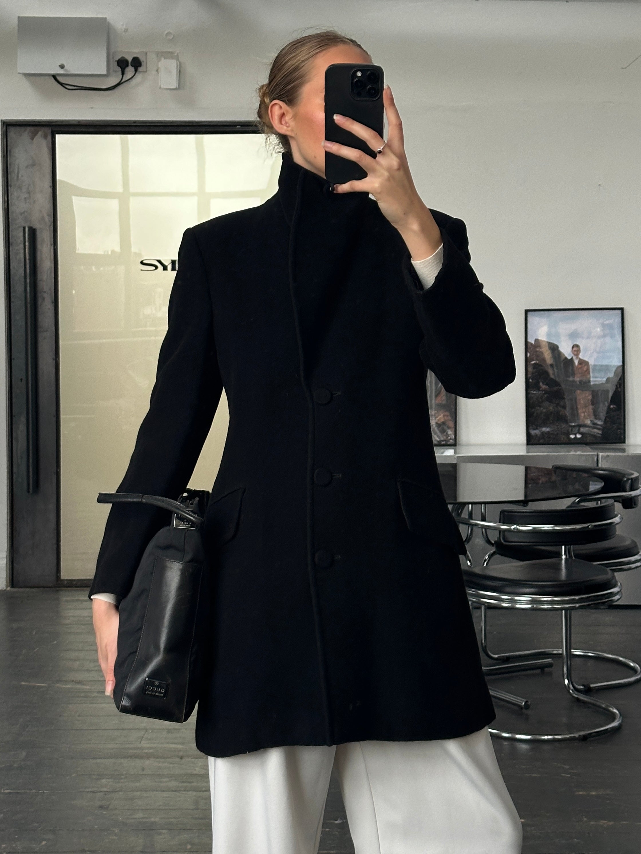 Emporio Armani 1990s wool camel coat in size S/M displayed on hanger, showcasing classic tailored design and warm fabric.