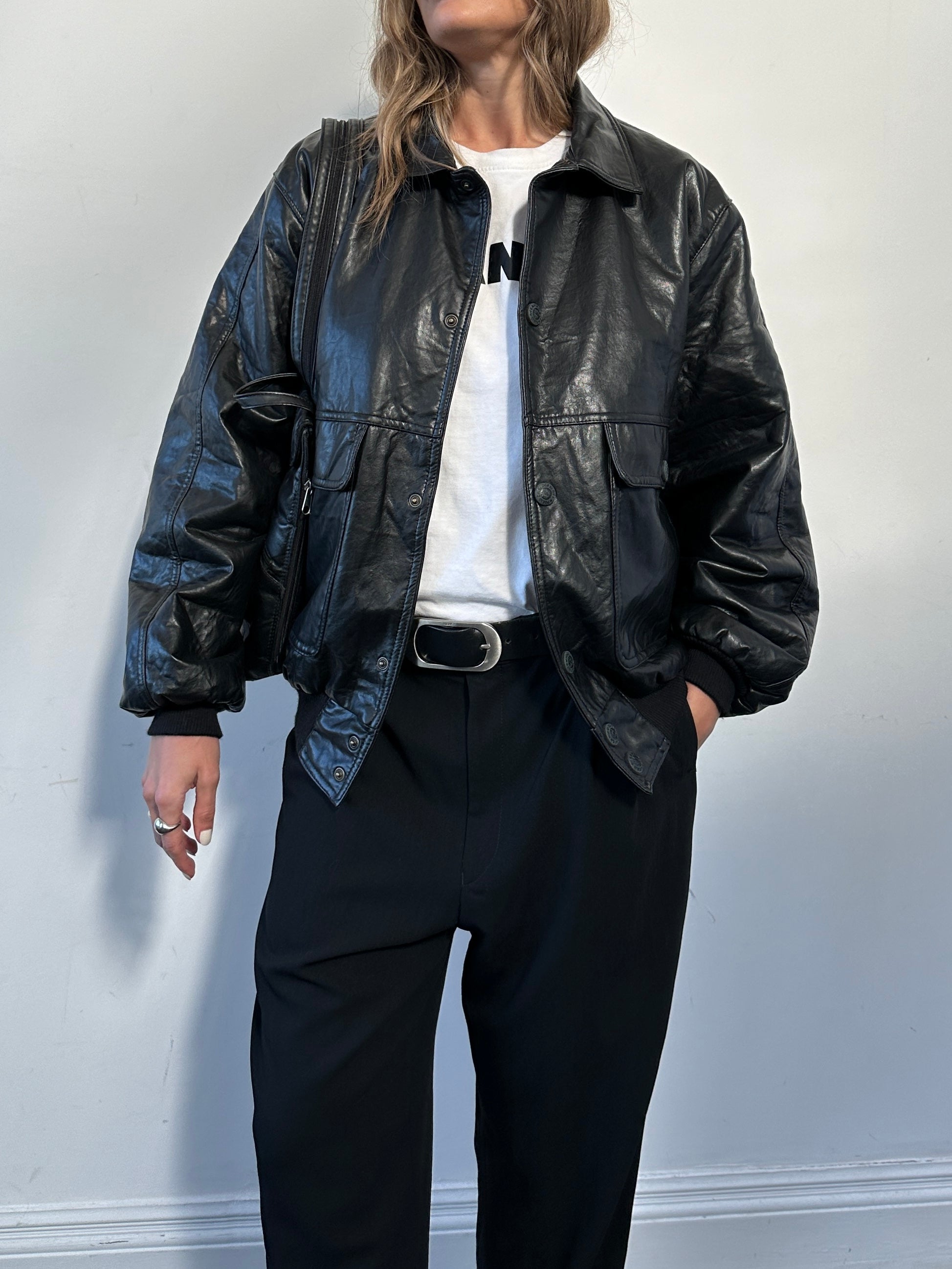 Vintage Italian faux leather bomber jacket in size large, with classic design and textured finish visible in the image.