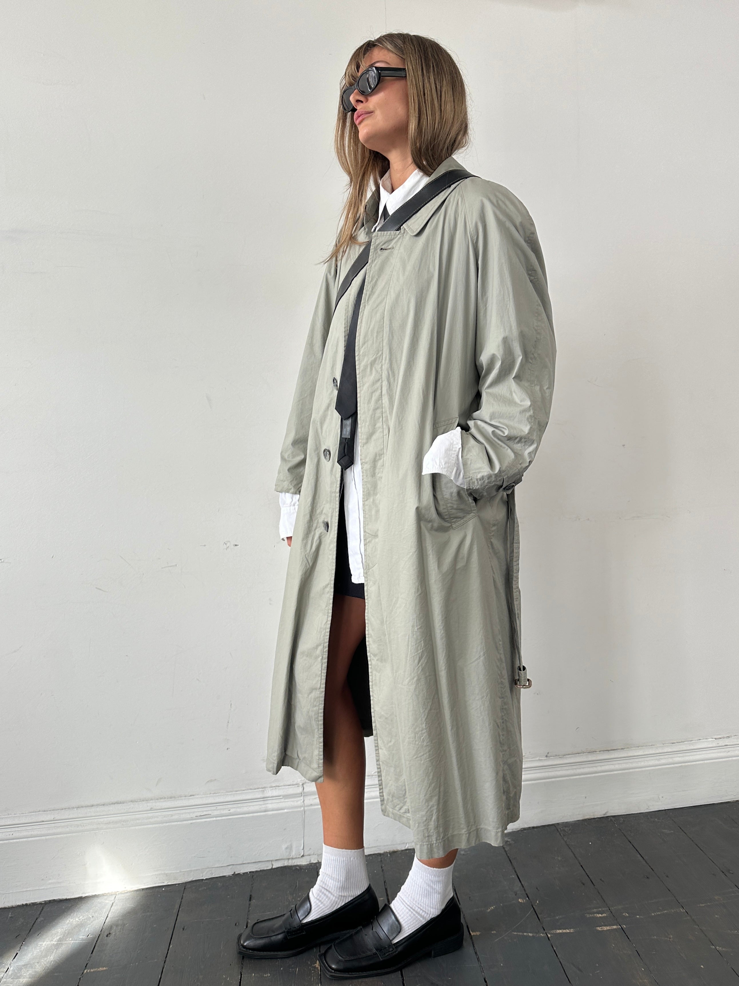 Christian Dior Le Connaisseur belted trench coat in beige, tailored fit, with classic collar and button details.