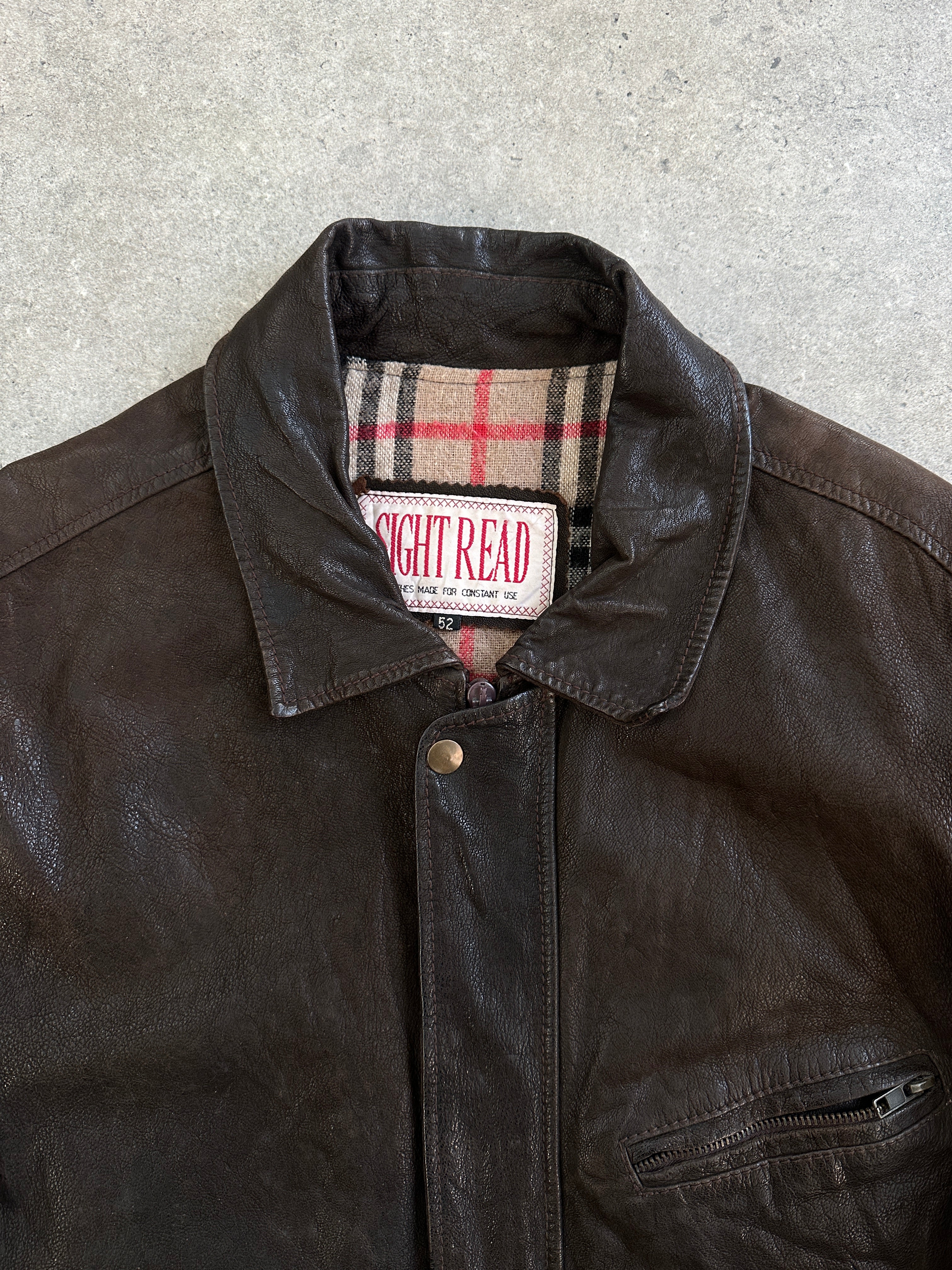 Vintage 1980s leather jacket with concealed placket in size L/XL, featuring classic vintage style and high-quality leather material.