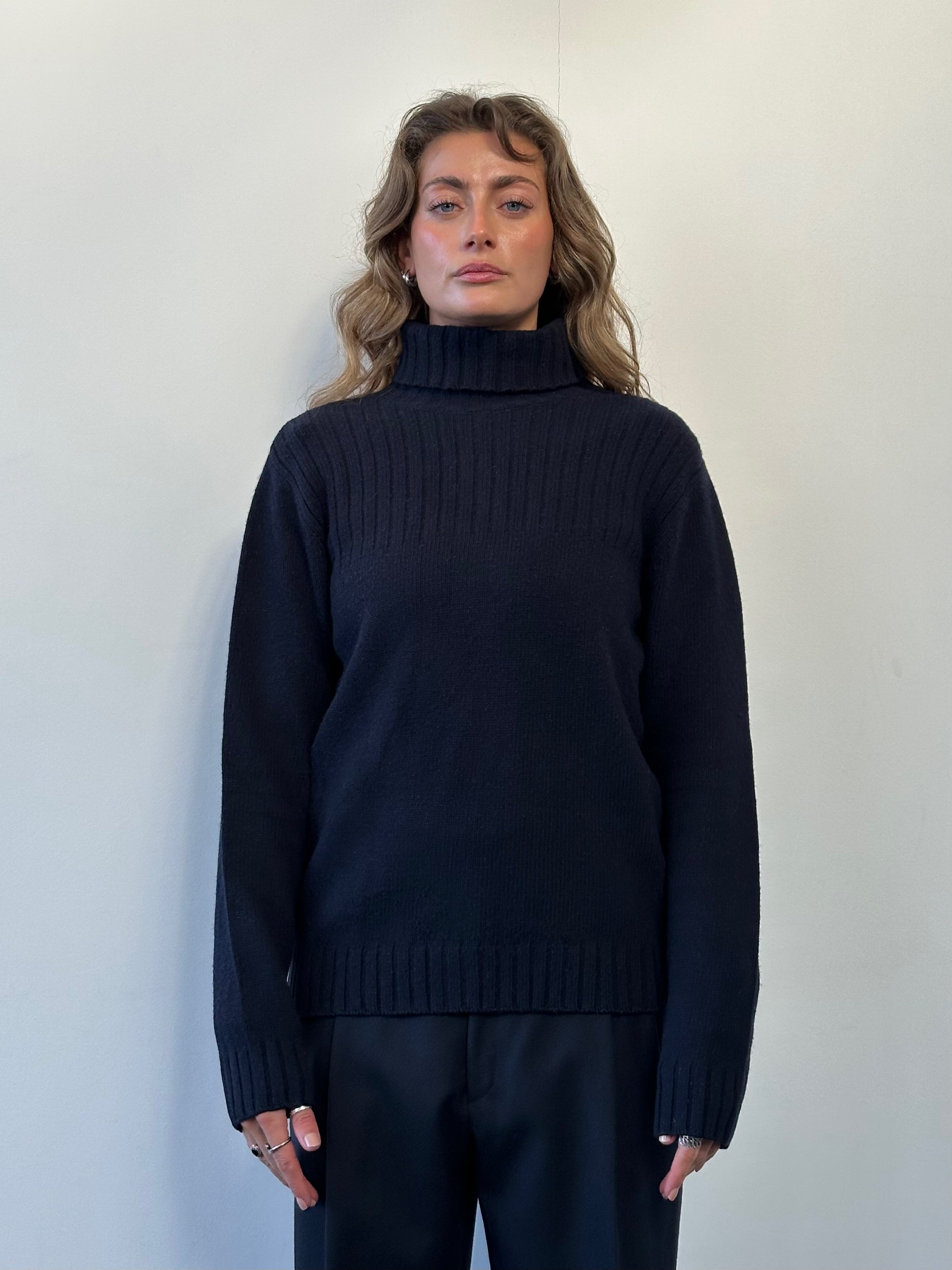 Barbour Pure Wool Roll Neck Jumper in size M, featuring a classic knitted design and a comfortable fit, displayed on a neutral background.