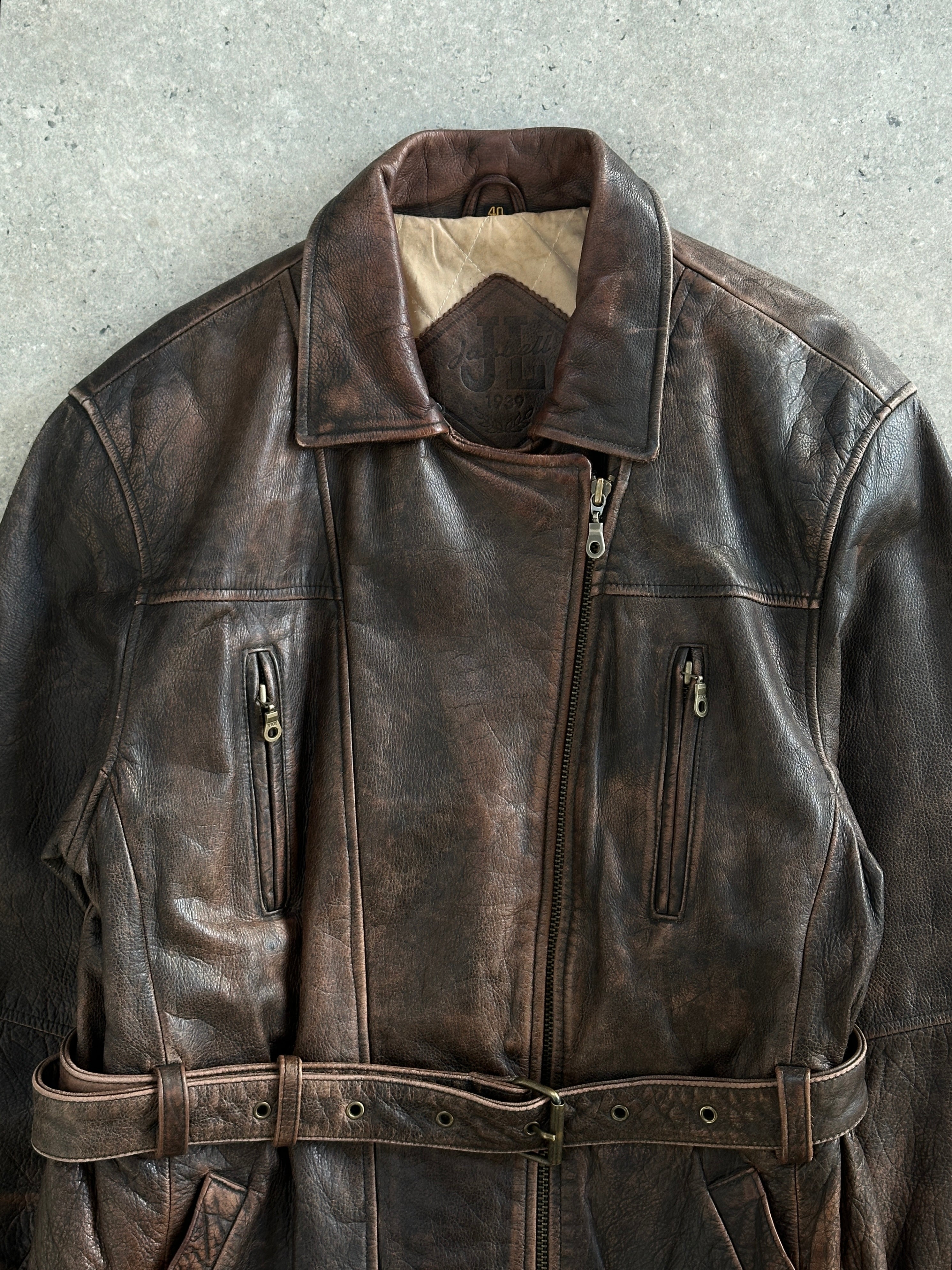 Vintage brand vintage 1980s belted leather jacket in size L, aged leather with classic design and metal buckle details.