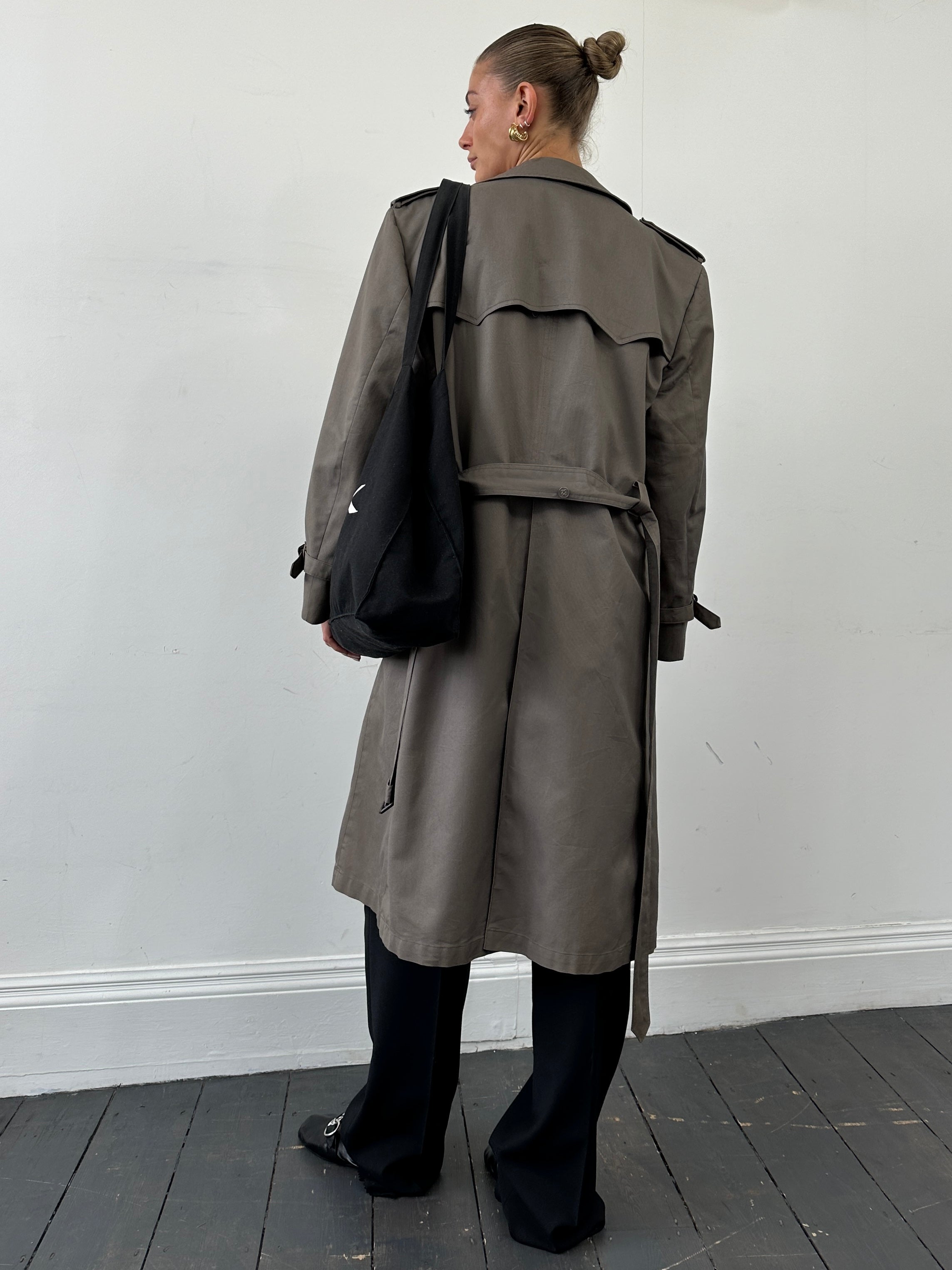 Christian Dior Monsieur double-breasted belted trench coat in dark fabric, showcasing classic design and tailored fit.