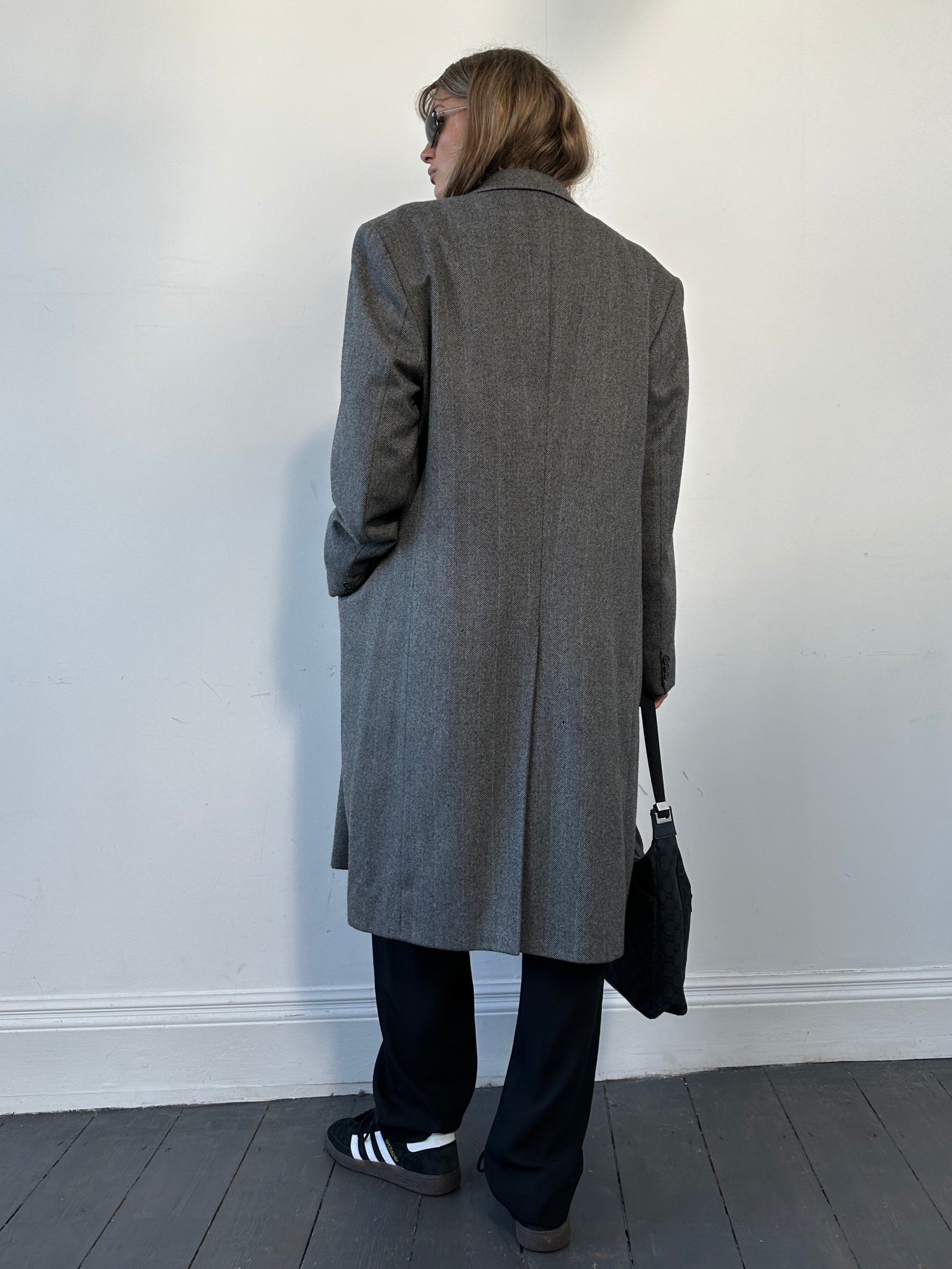 Vintage British vintage pure wool double-breasted herringbone coat in size L/XL, showcasing classic tailored design and textured fabric.