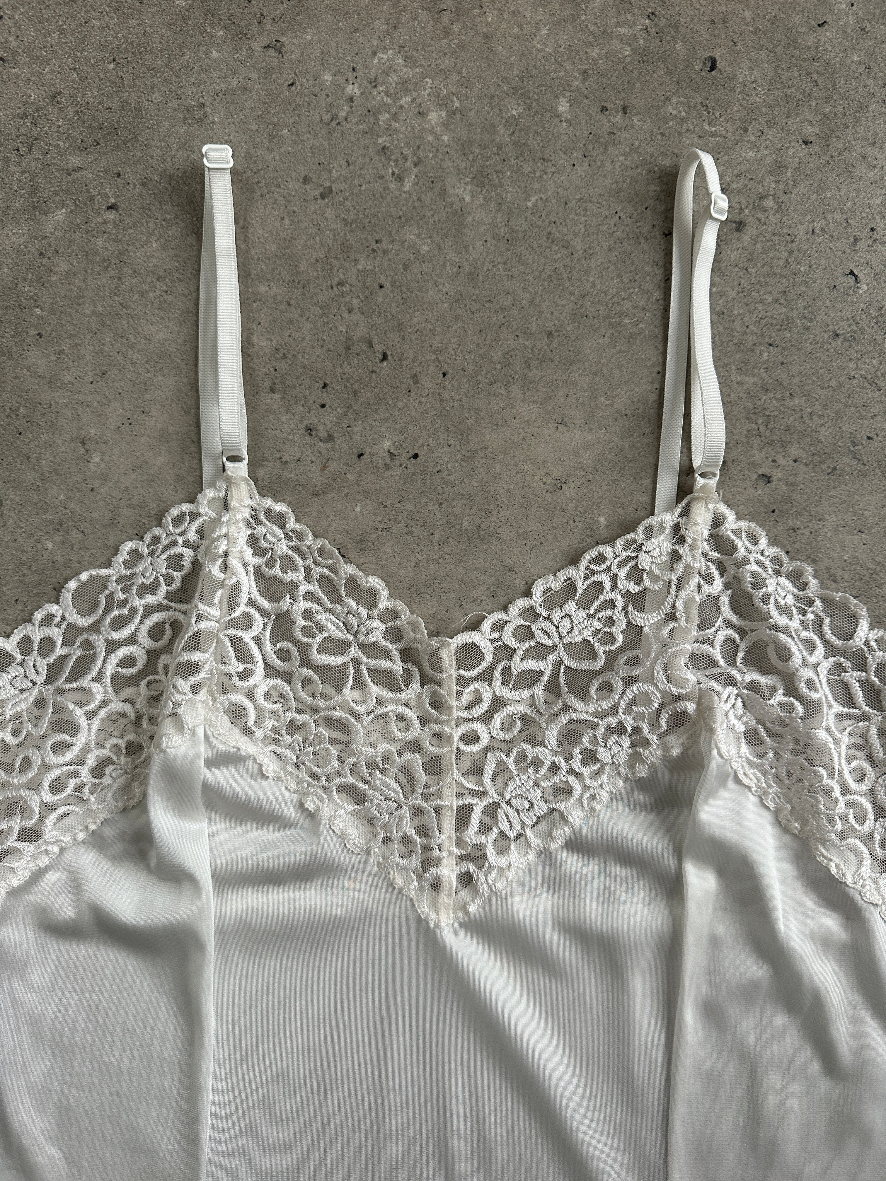 Japanese vintage 1990s lace sheer mini slip dress by Vintage, featuring delicate lace fabric and a classic mini length.