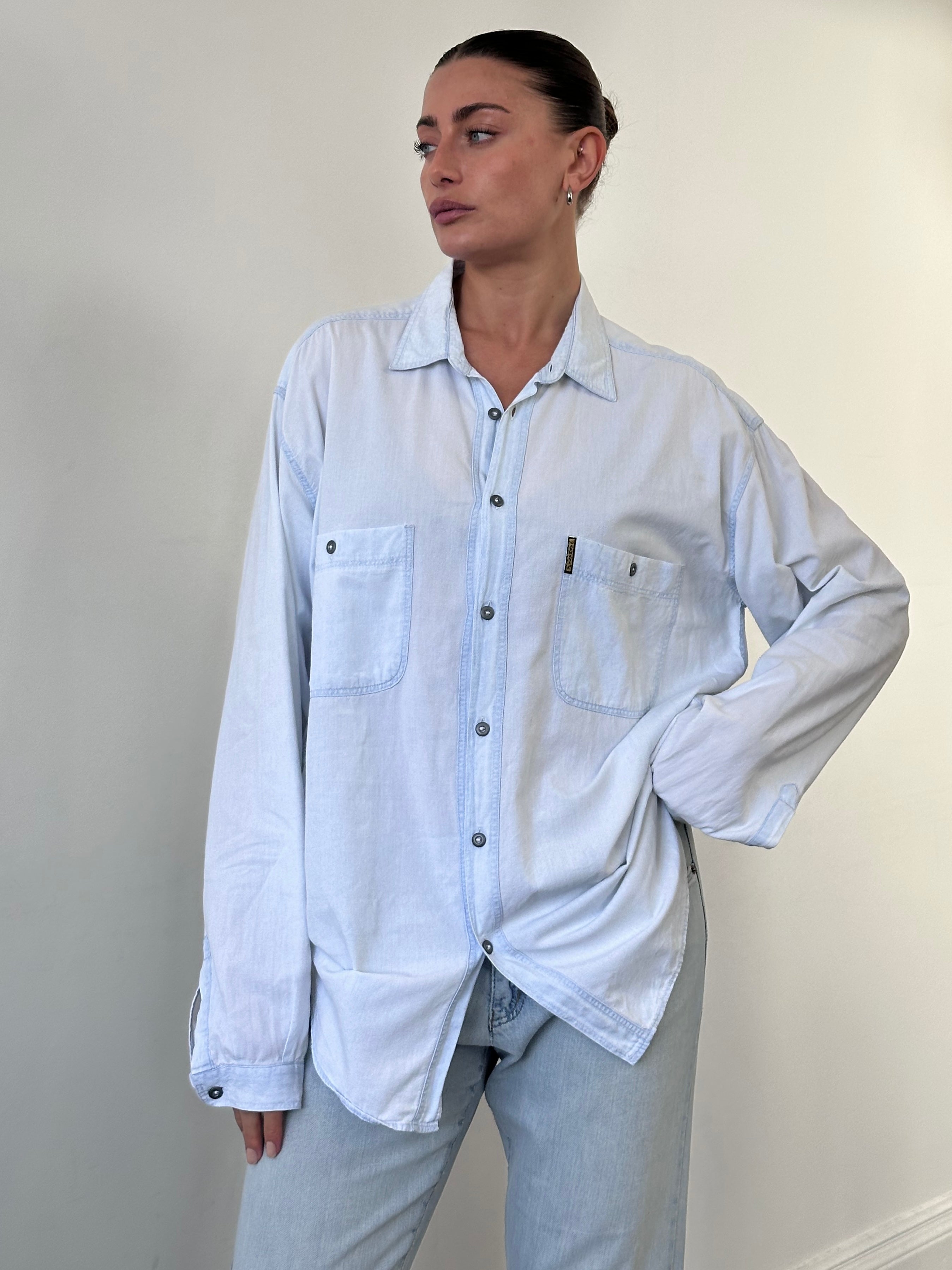 Armani Jeans light wash denim shirt in XL with classic collar and button-front design, shown on a hanger.