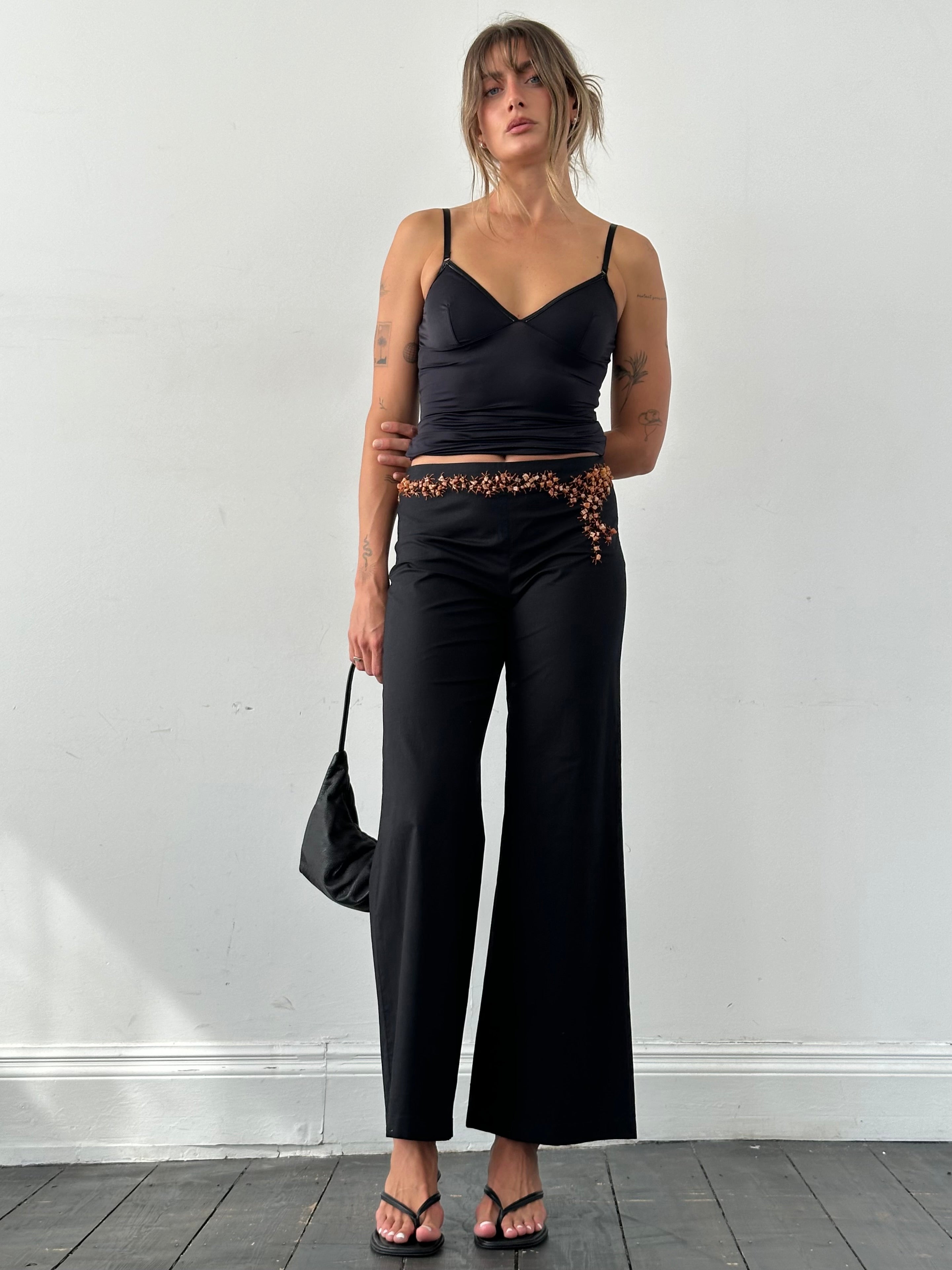 Vintage Alberta Ferretti mid waist wide leg trousers with stone embellishments, shown in a natural pose on a neutral background.
