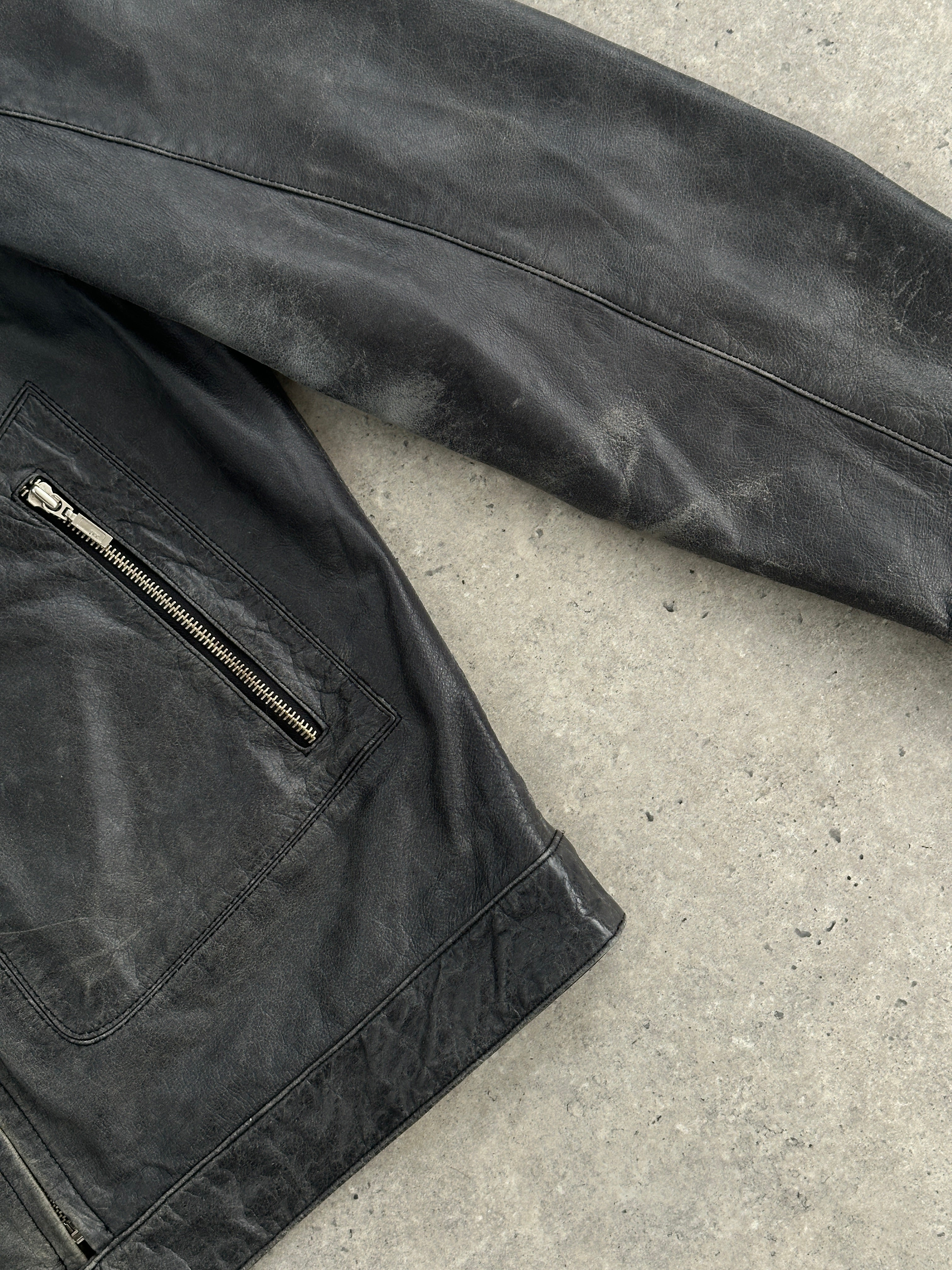 Vintage distressed leather moto jacket in size L/XL, featuring rugged styling and classic motorcycle-inspired design.