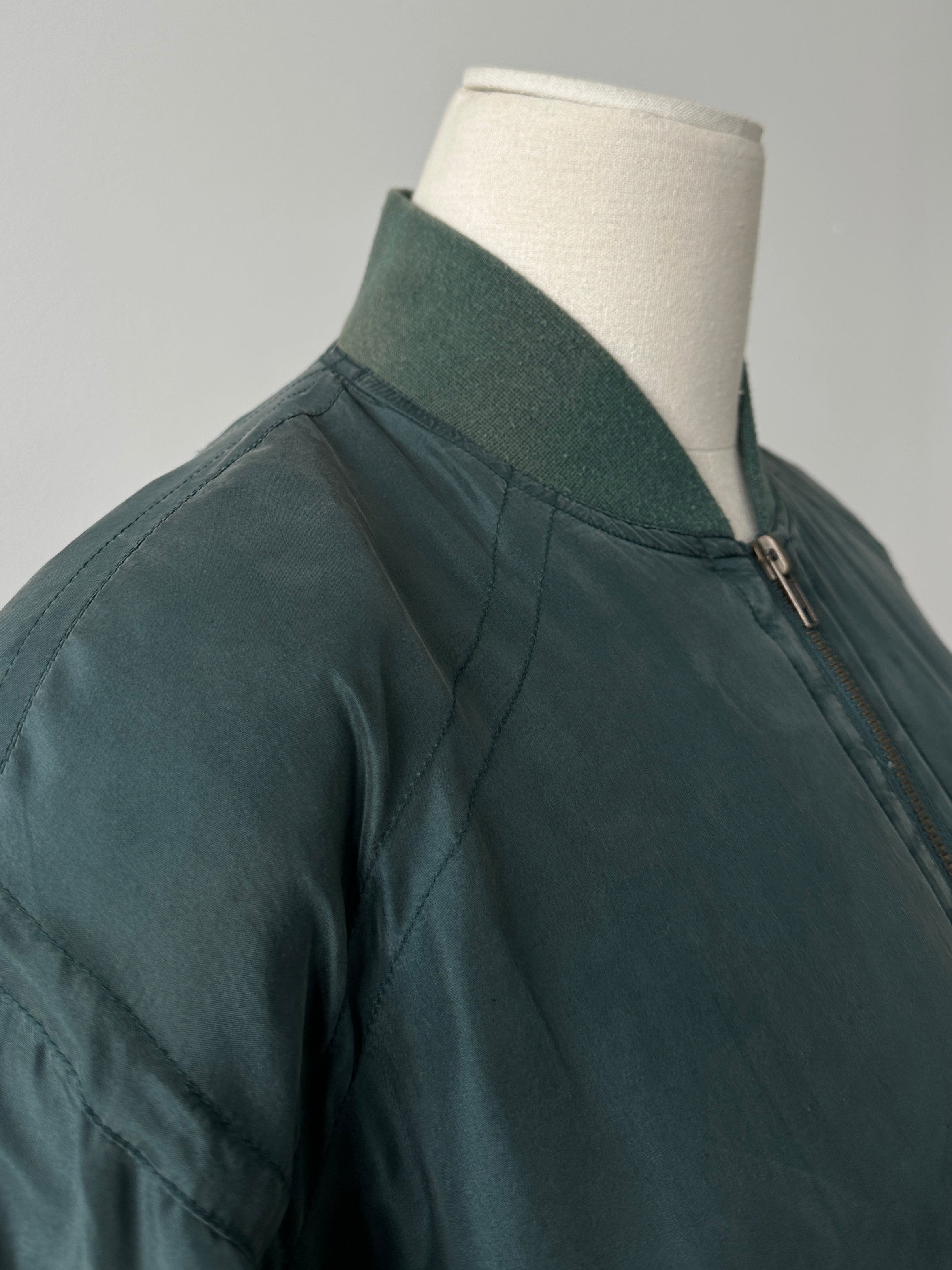 Vintage 1990s pure silk bomber jacket in size M, featuring a classic design with ribbed cuffs and collar, front zipper closure.
