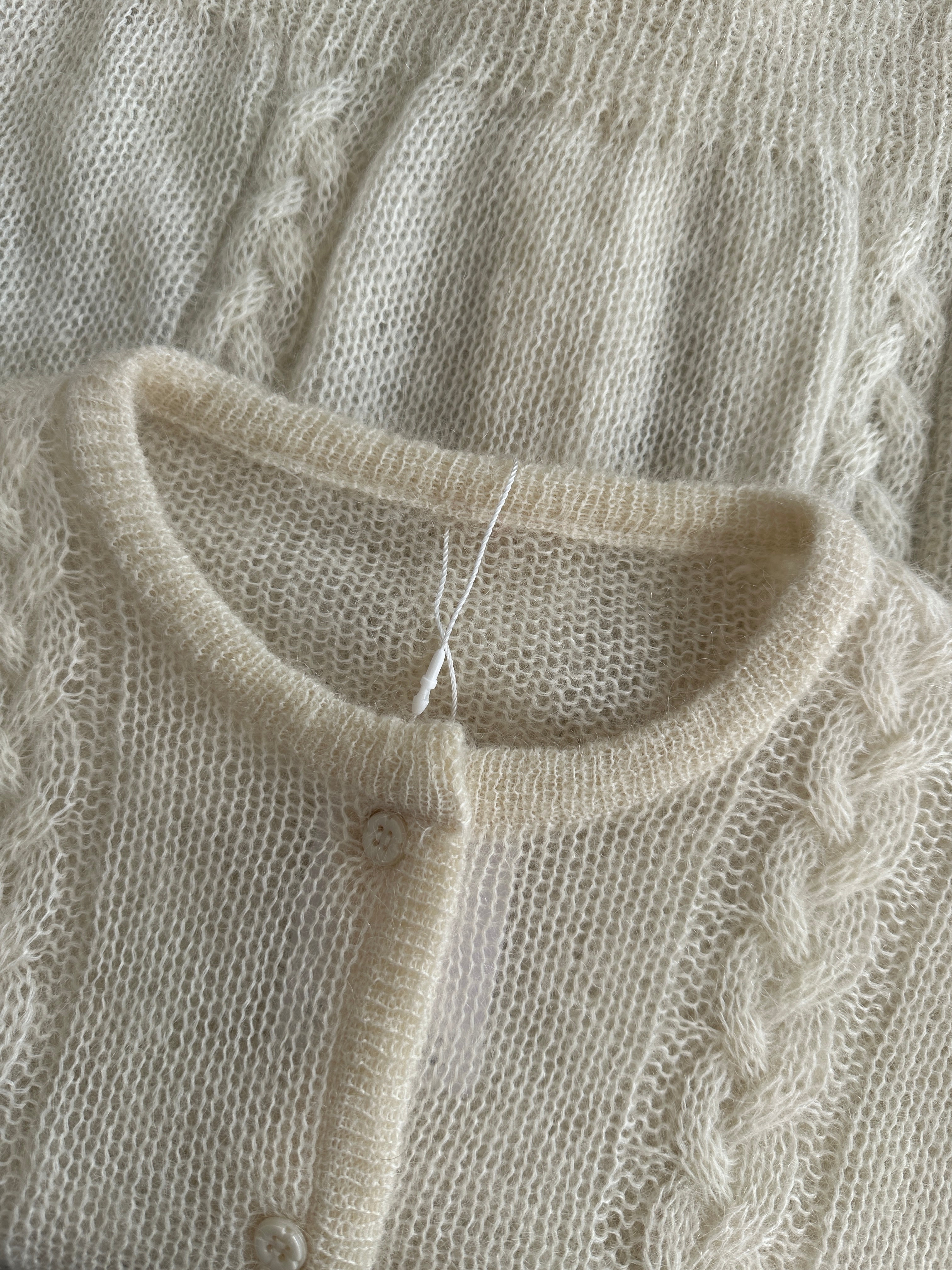 Vintage wool mohair cardigan in size L, featuring a classic knit design and button-front closure, styled on a neutral background.