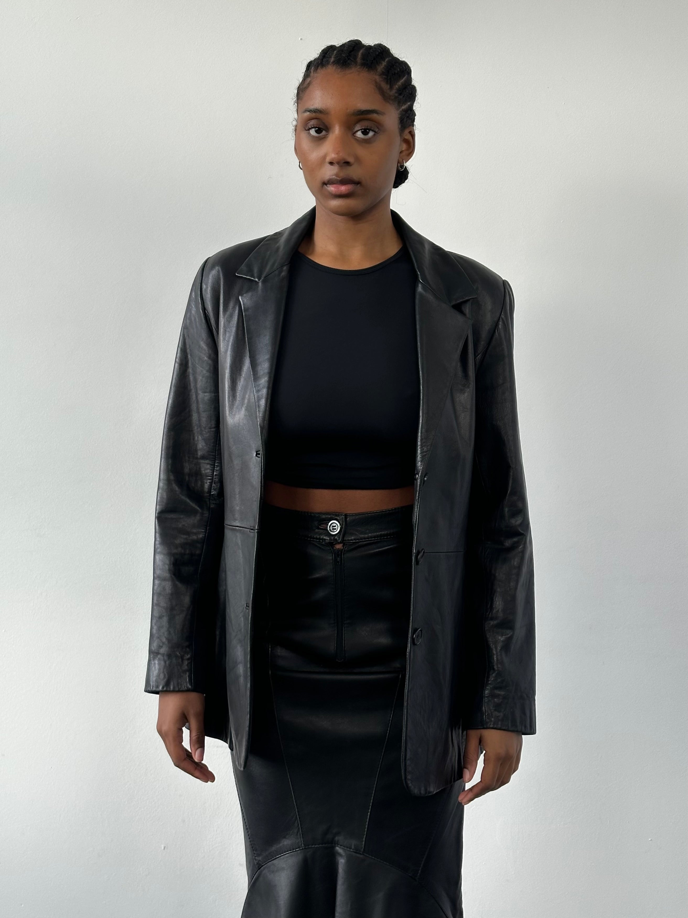 Vintage 1990s fitted leather jacket in size small, classic black leather with stylish collar and zip closure.