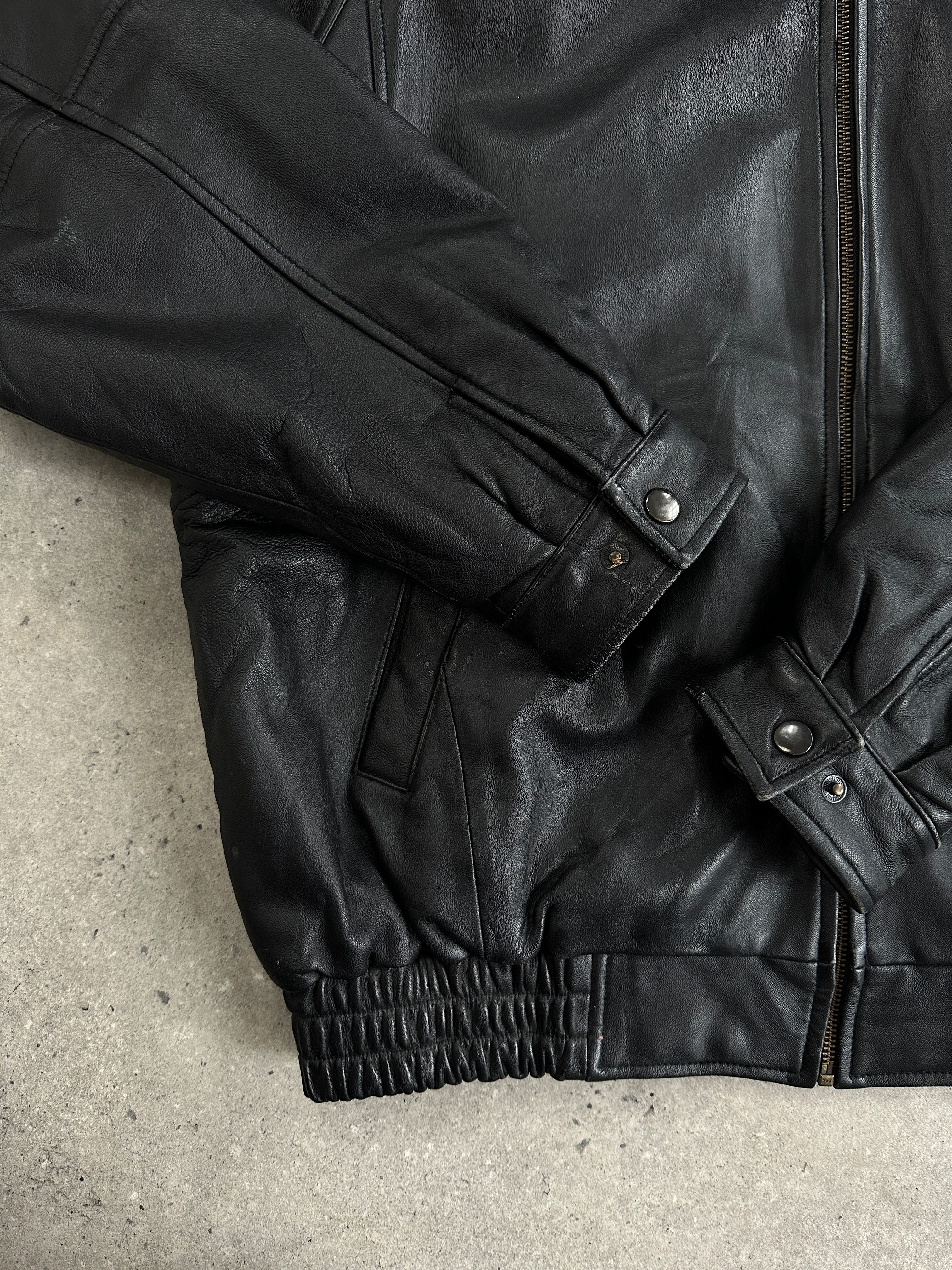 Vintage leather bomber jacket with intricate embroidery, size L/XL, stylish vintage leather jacket for a classic look.