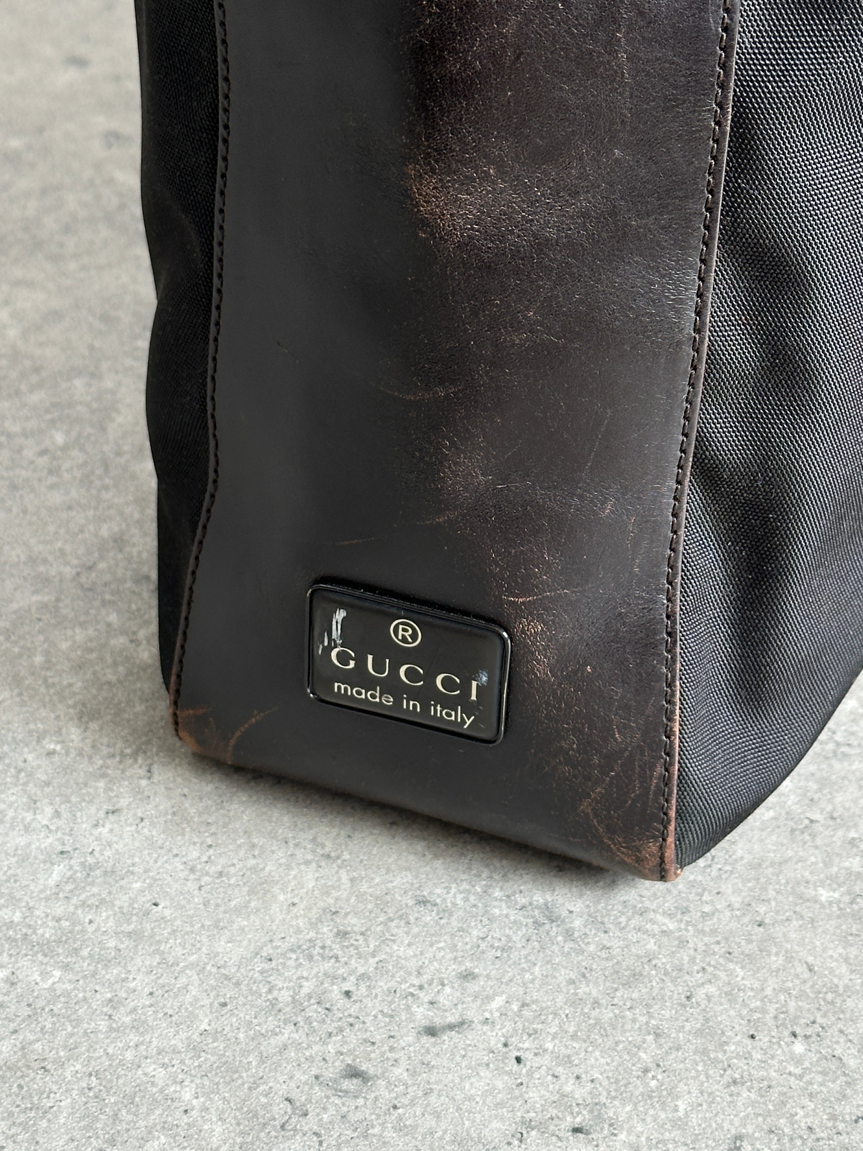 Gucci canvas and leather shoulder bag with adjustable strap and signature design, featuring classic logo accents.