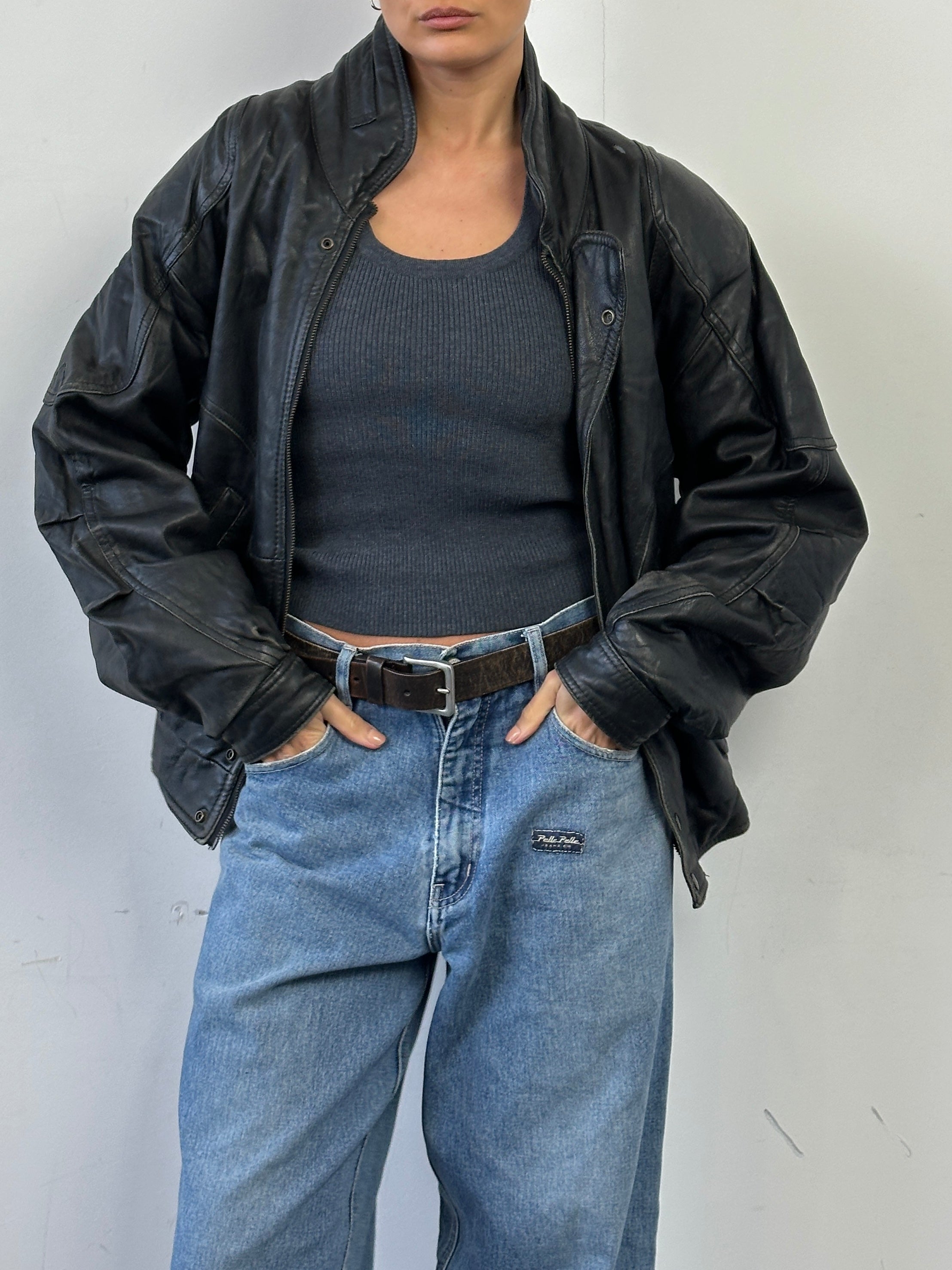 Vintage leather bomber jacket in medium size with classic design and smooth brown leather, stylish and durable for casual wear.