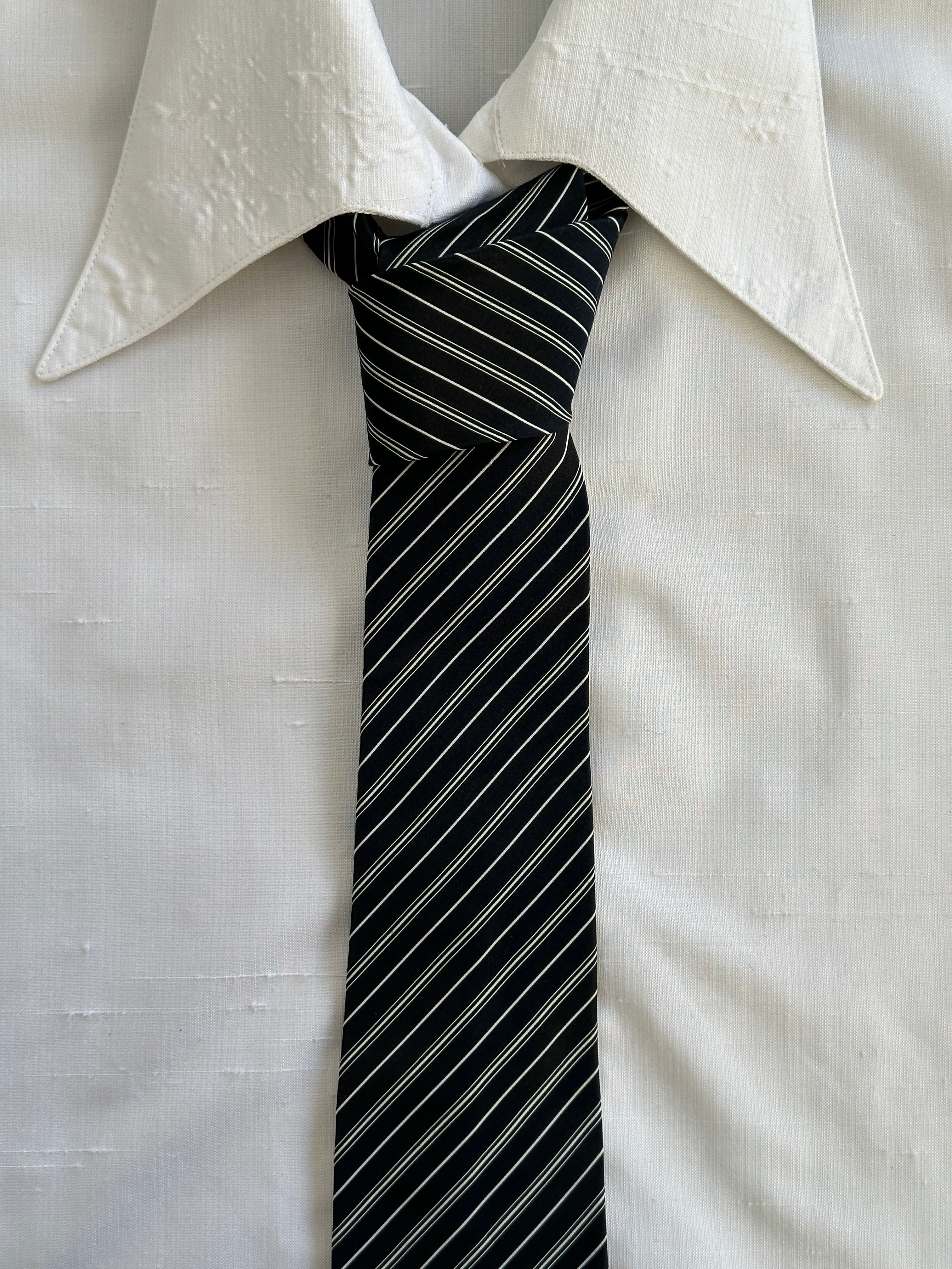 Vintage 1990s pure silk striped tie featuring classic pattern and vibrant colors, ideal for formal or professional wear.