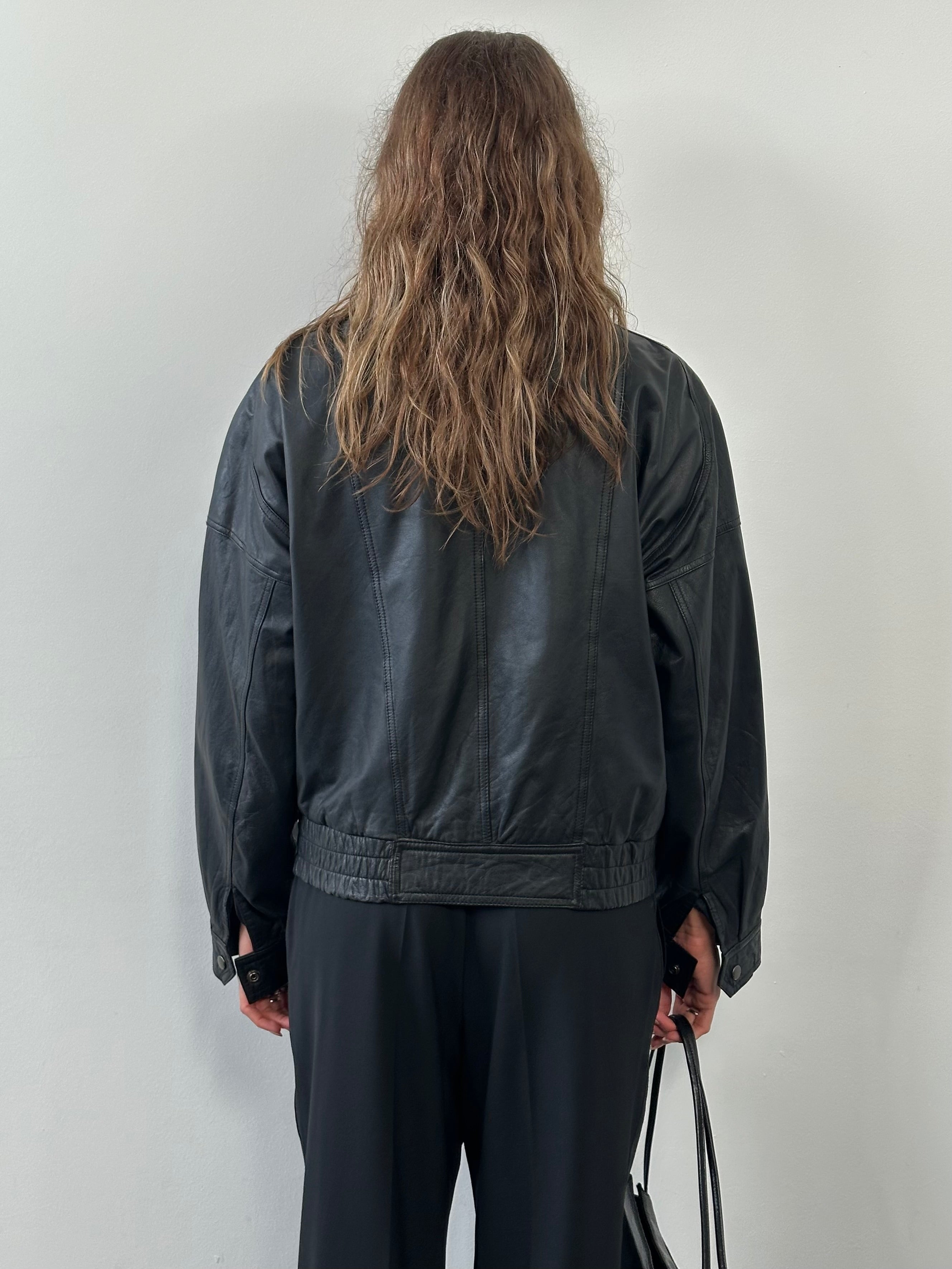 Vintage 1990s leather bomber jacket in medium size, featuring classic design and distressed leather from the Vintage brand.