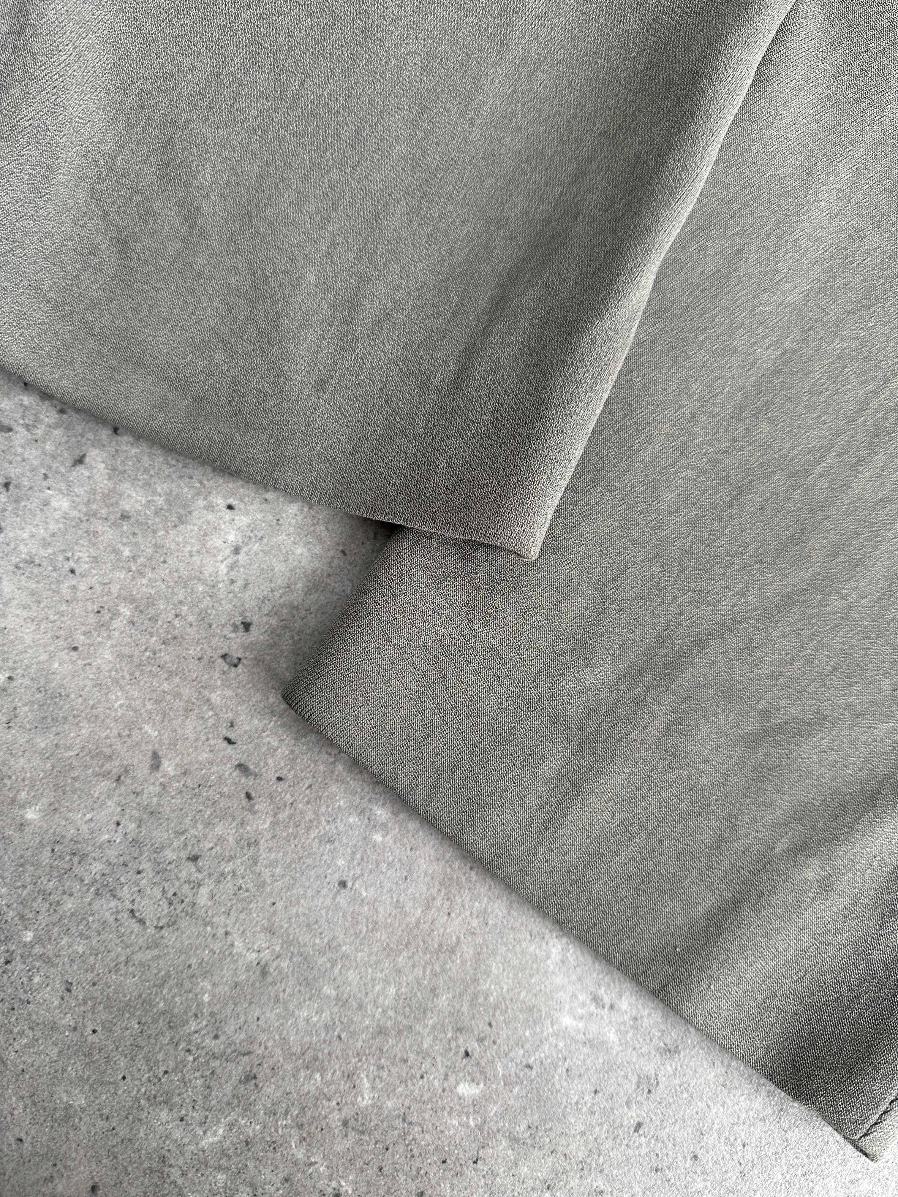 Giorgio Armani high-waisted tapered leg trousers in neutral fabric, displayed on a hanger with a white background.
