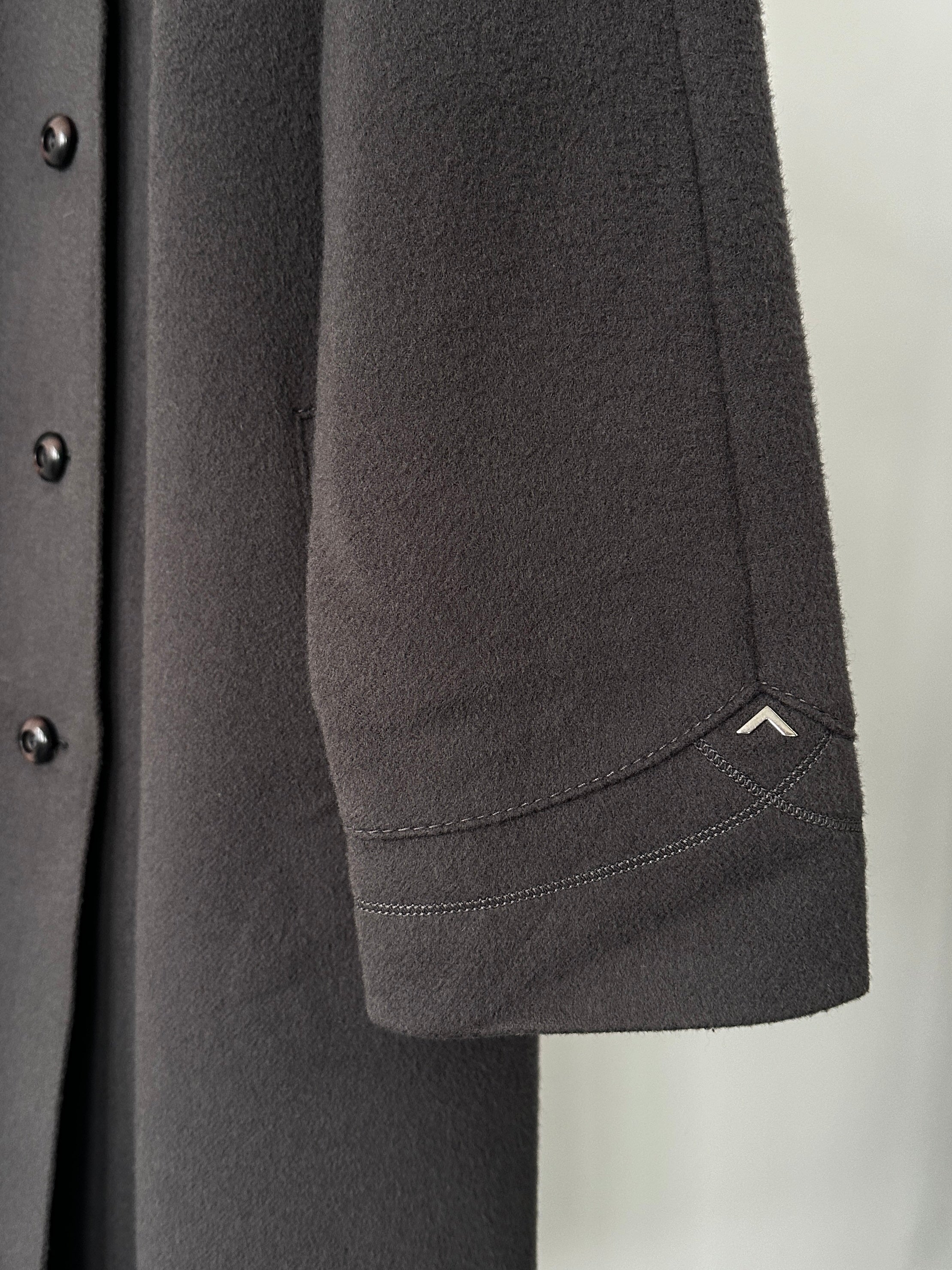 Vintage wool single-breasted coat shown on a hanger, in size M, featuring classic design and textured fabric.