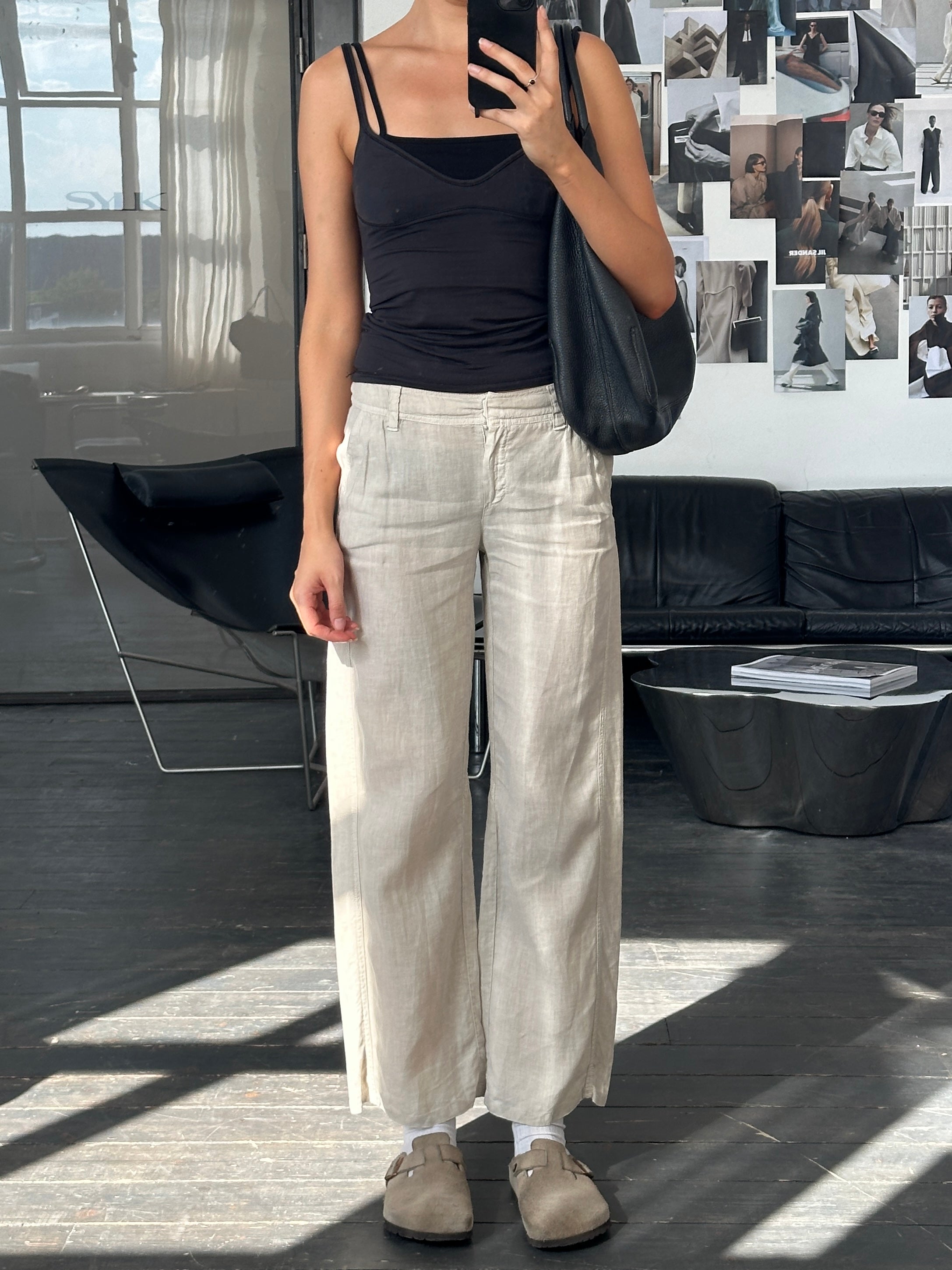 Marella 2000s low waisted straight leg trousers in black fabric, displayed on a hanger with a clean background.
