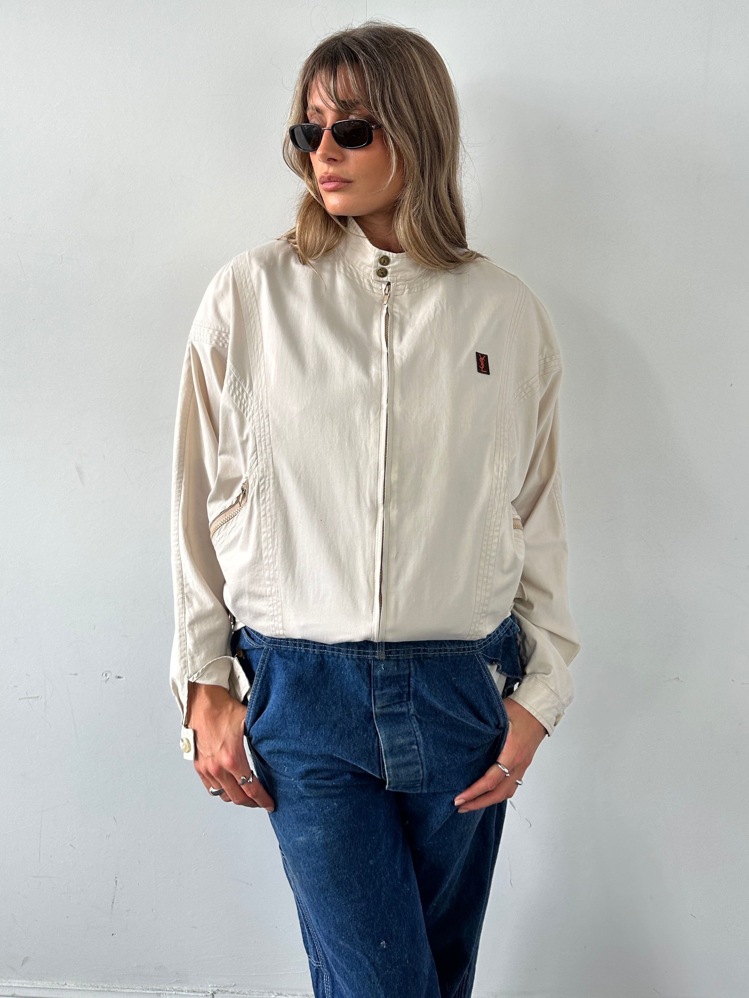 Yves Saint Laurent 70s Logo Bomber Jacket in black with YSL logo patches, front zipper, and ribbed cuffs and collar.