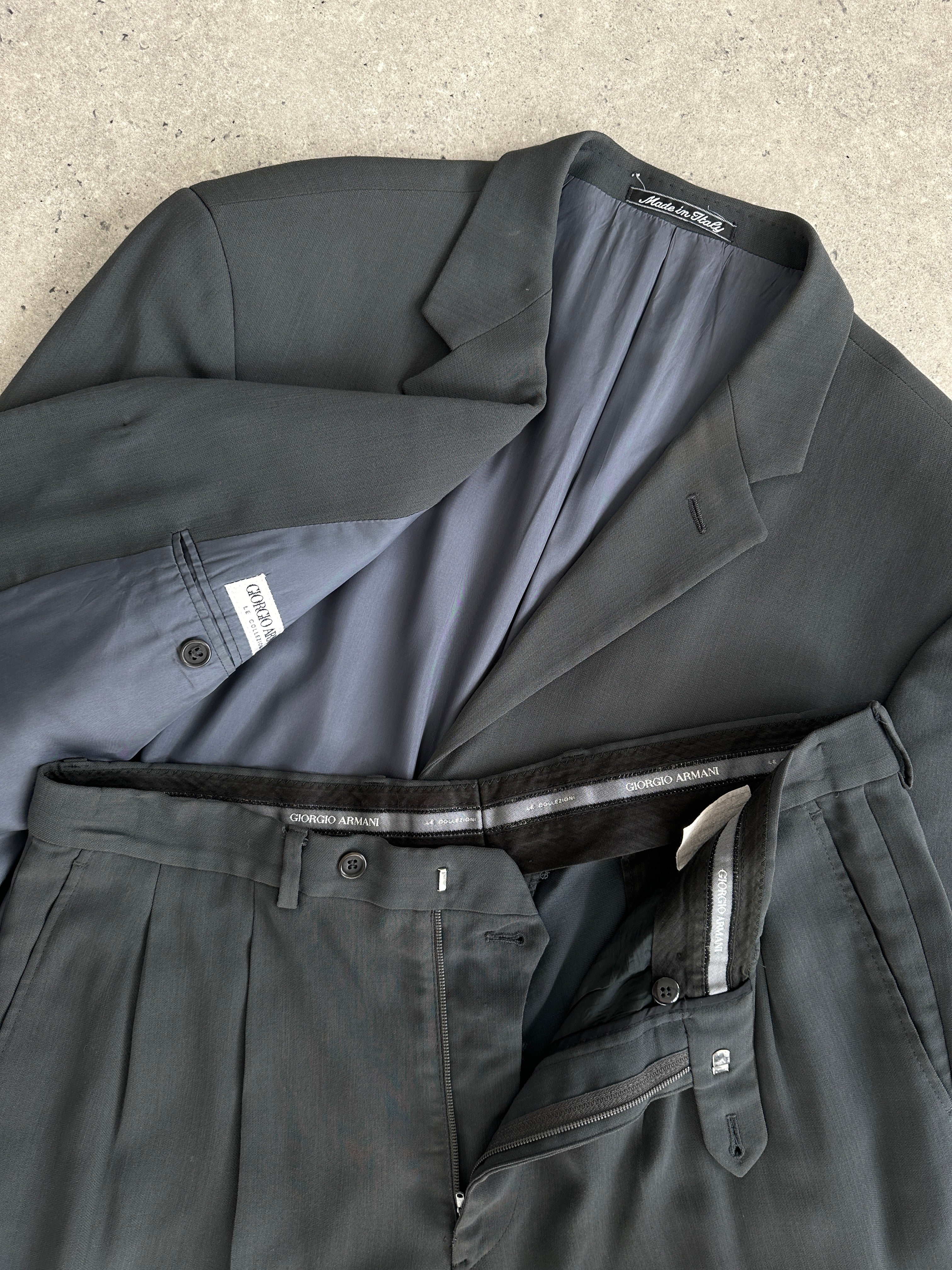 Giorgio Armani Le Collezioni wool relaxed single-breasted suit jumpsuit in size 42R/W34, tailored fit with lapel collar and front buttons.