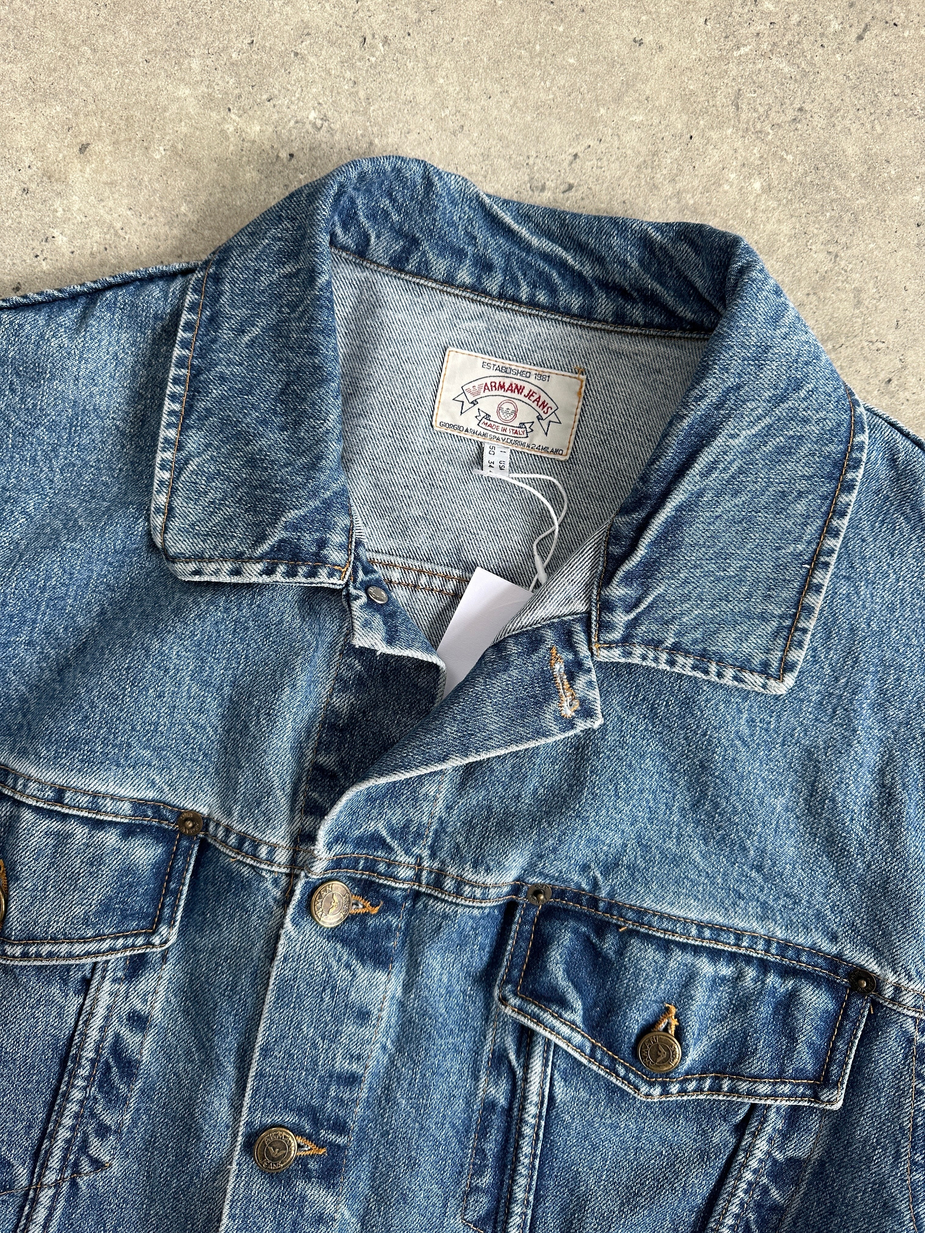 Armani Jeans mid wash denim jacket in size L, showcasing classic fit with button closure and chest pockets.
