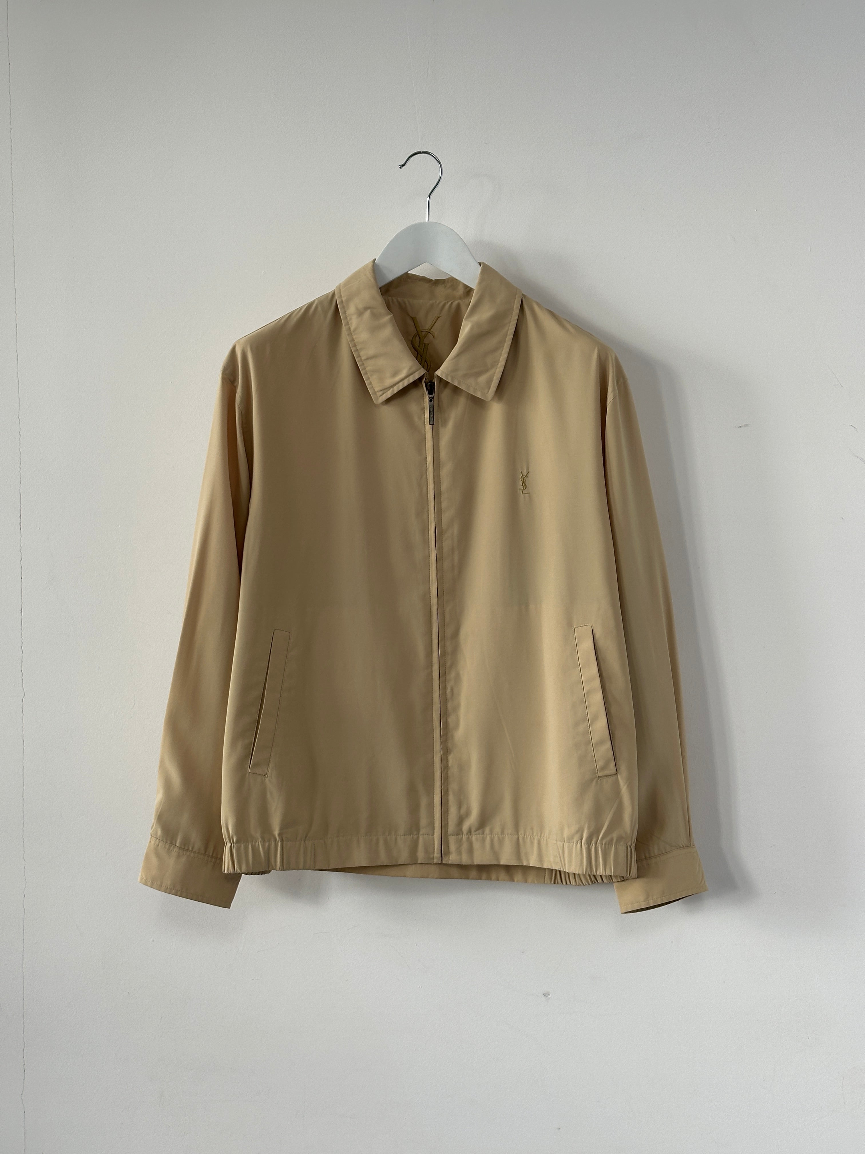 Yves Saint Laurent Pour Homme logo bomber jacket in black with front zipper and ribbed cuffs, size M/L, displayed on a hanger.