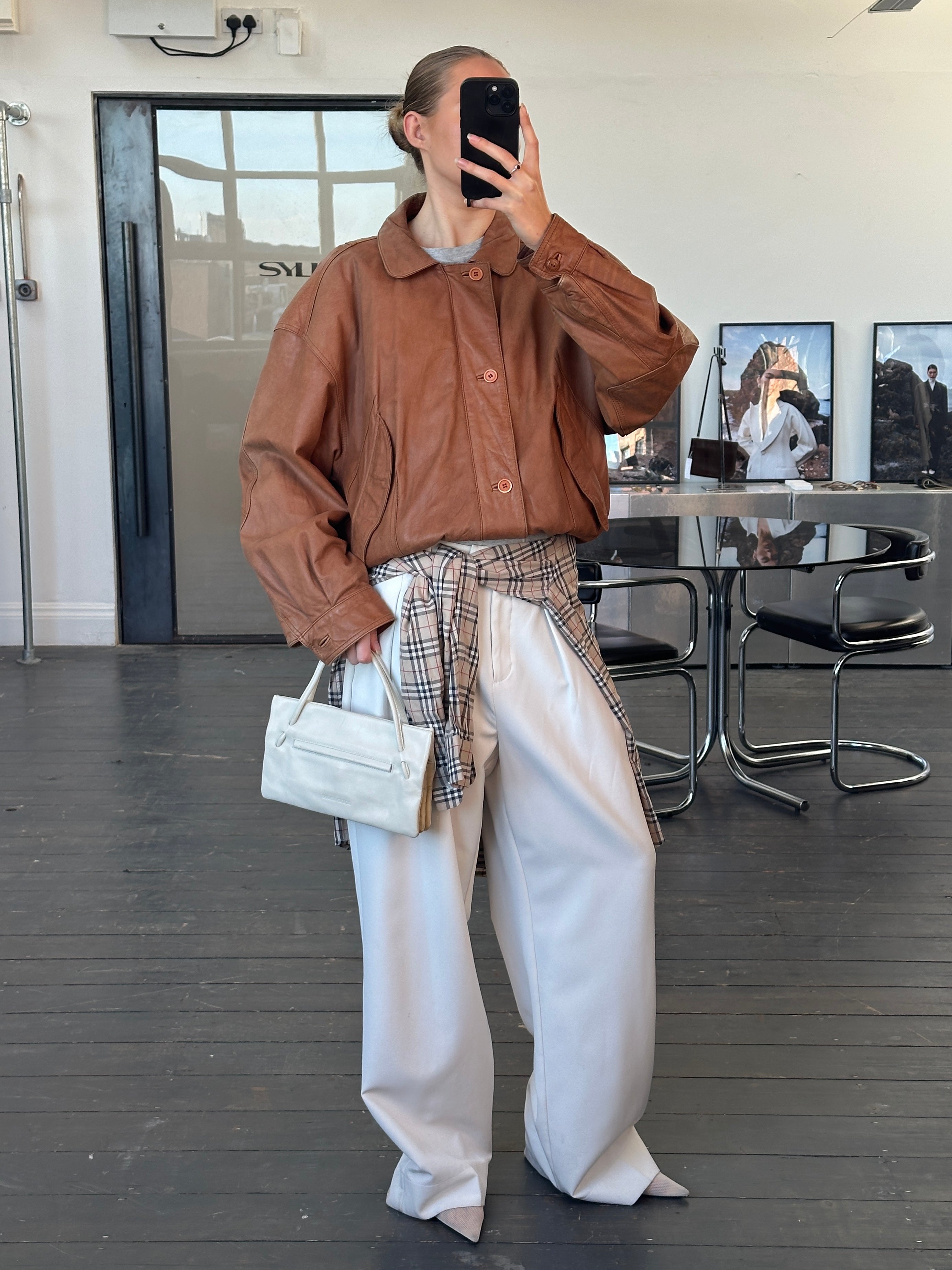 Vintage 1980s leather bomber jacket in size large, featuring classic design, brown leather, and vintage style details.