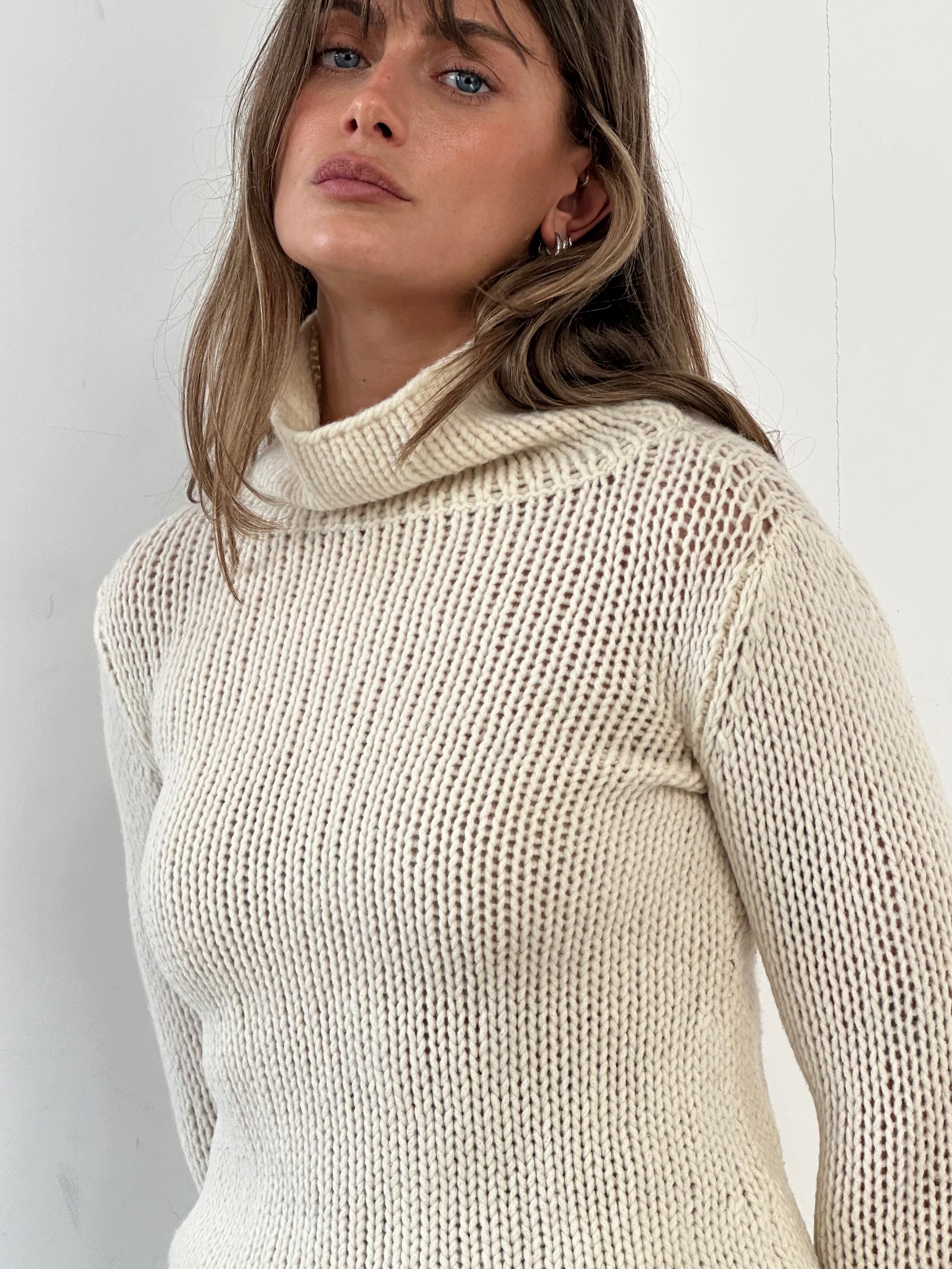 Max Mara Weekend wool knitted crop roll neck jumper in beige, showcasing the textured knit and fitted design on a neutral background.