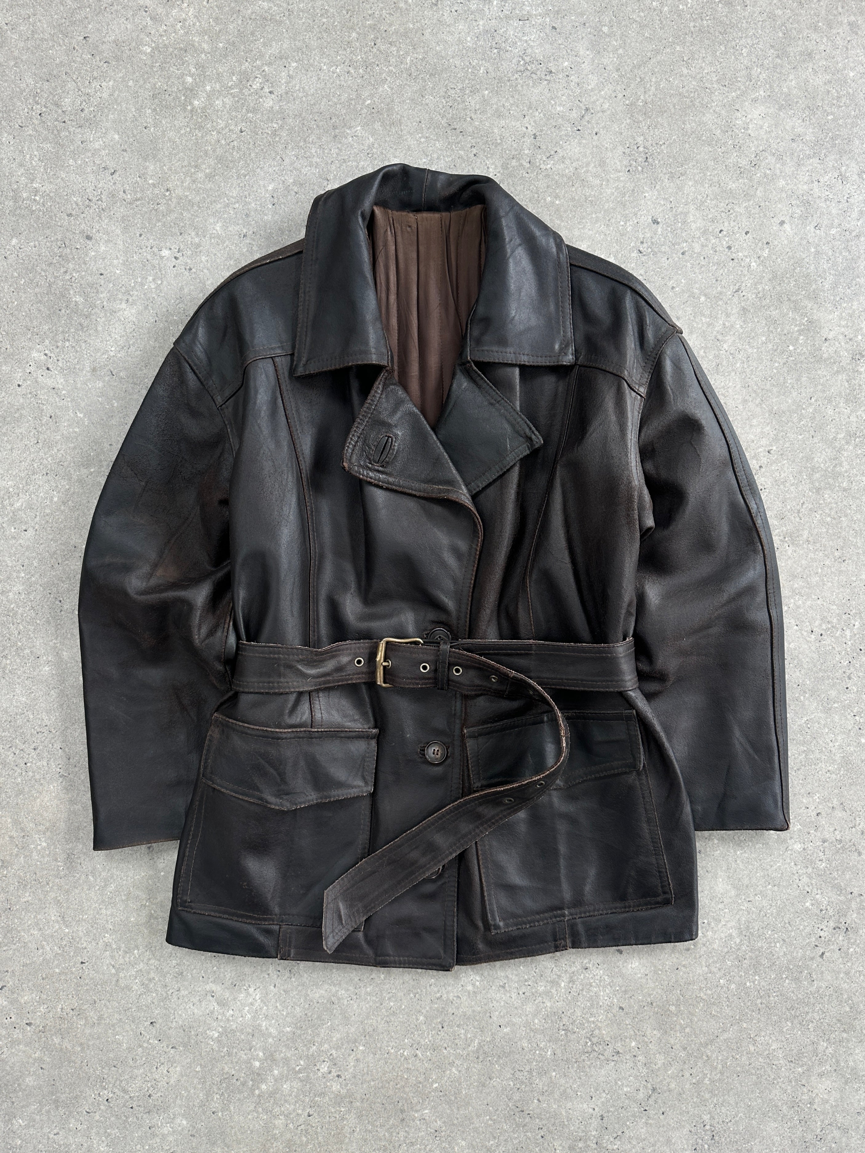 Vintage Italian 1980s belted leather jacket, medium size, with classic design and detailed stitching, displayed on a hanger.