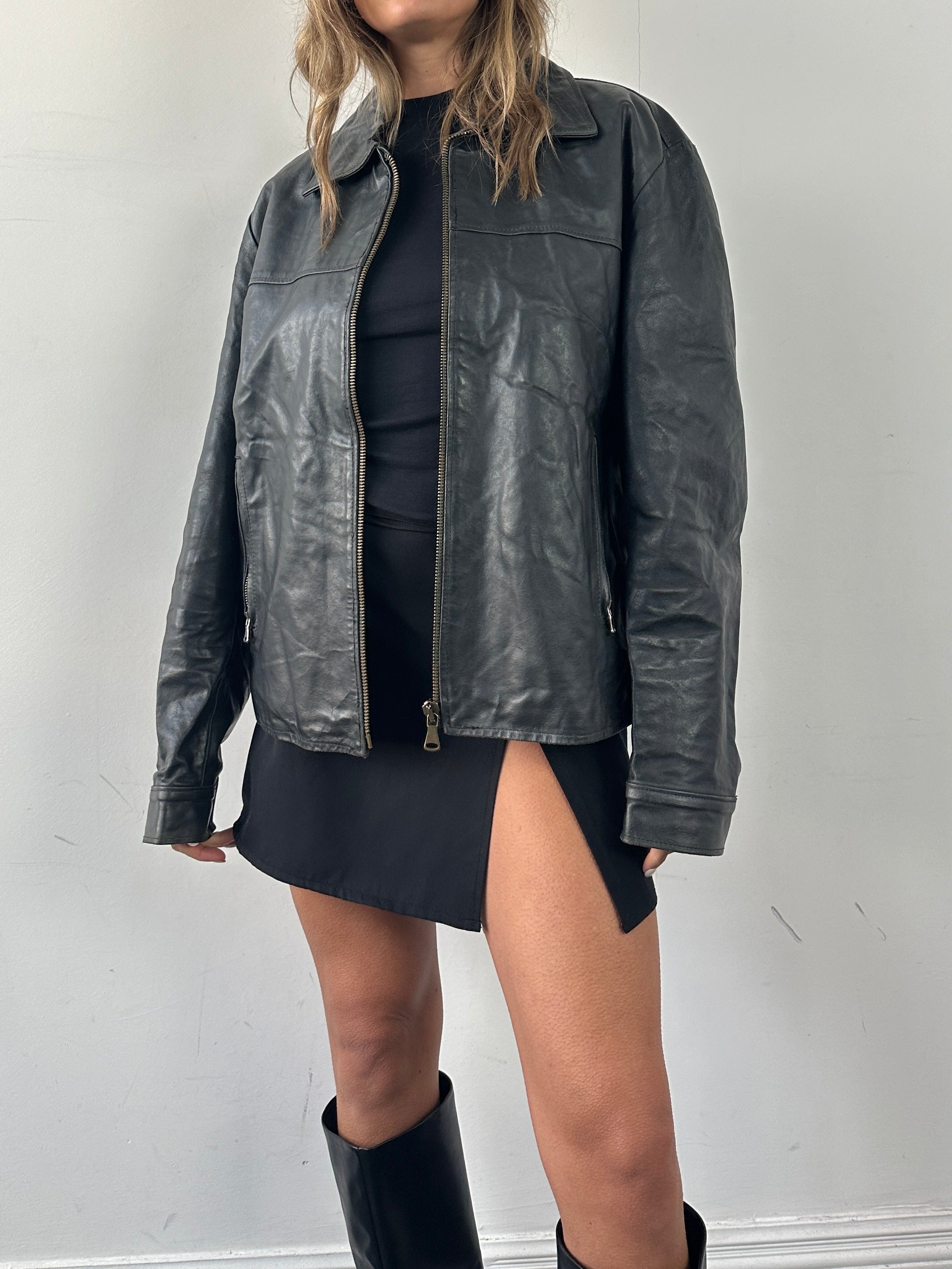 Vintage leather jacket in size L, featuring classic style and rich brown color, displayed on a hanger against a neutral background.