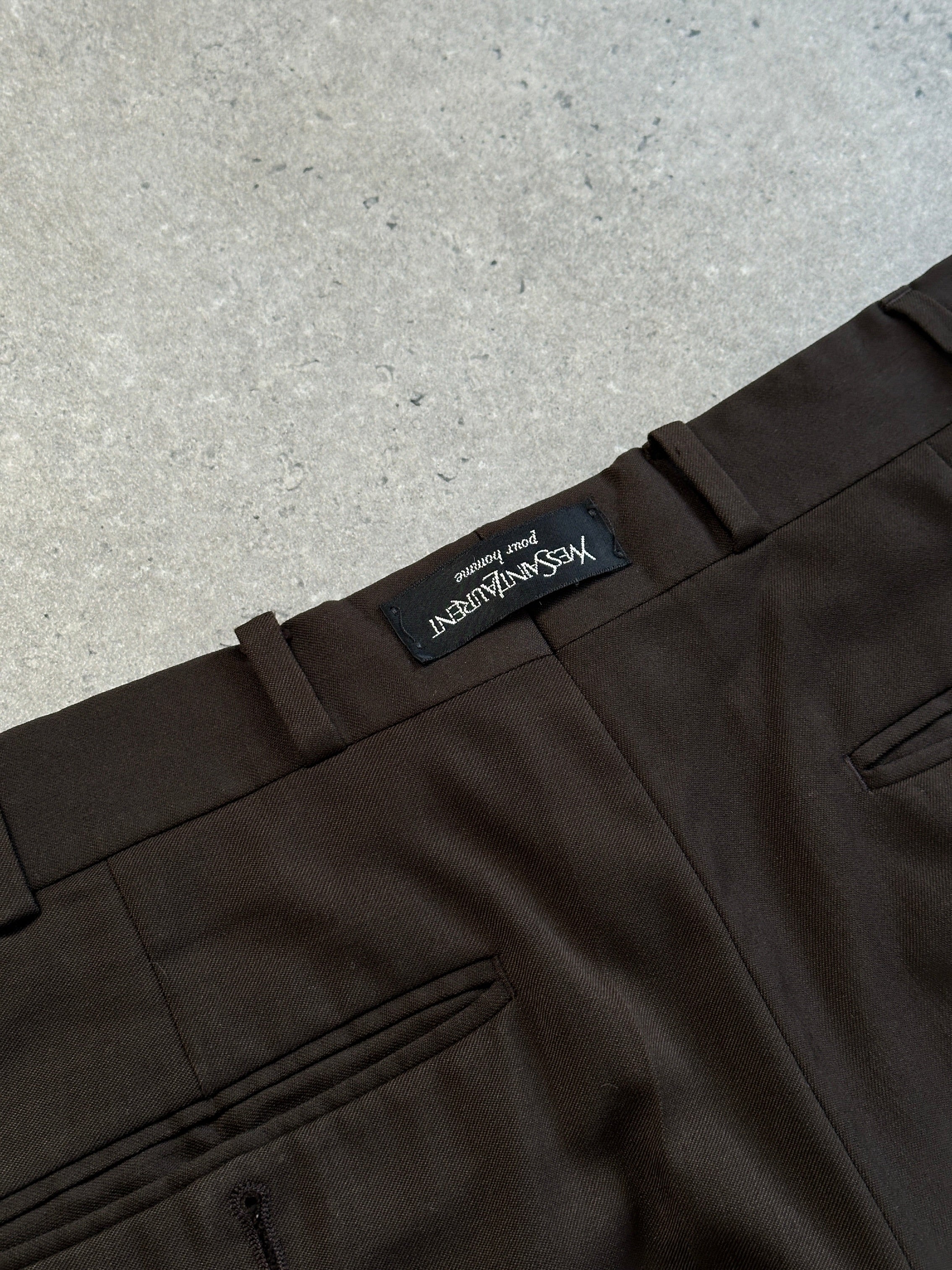 Yves Saint Laurent Pour Homme 1990s tailored wool trousers in size W28, showing a classic fit with a dark fabric and tailored details.