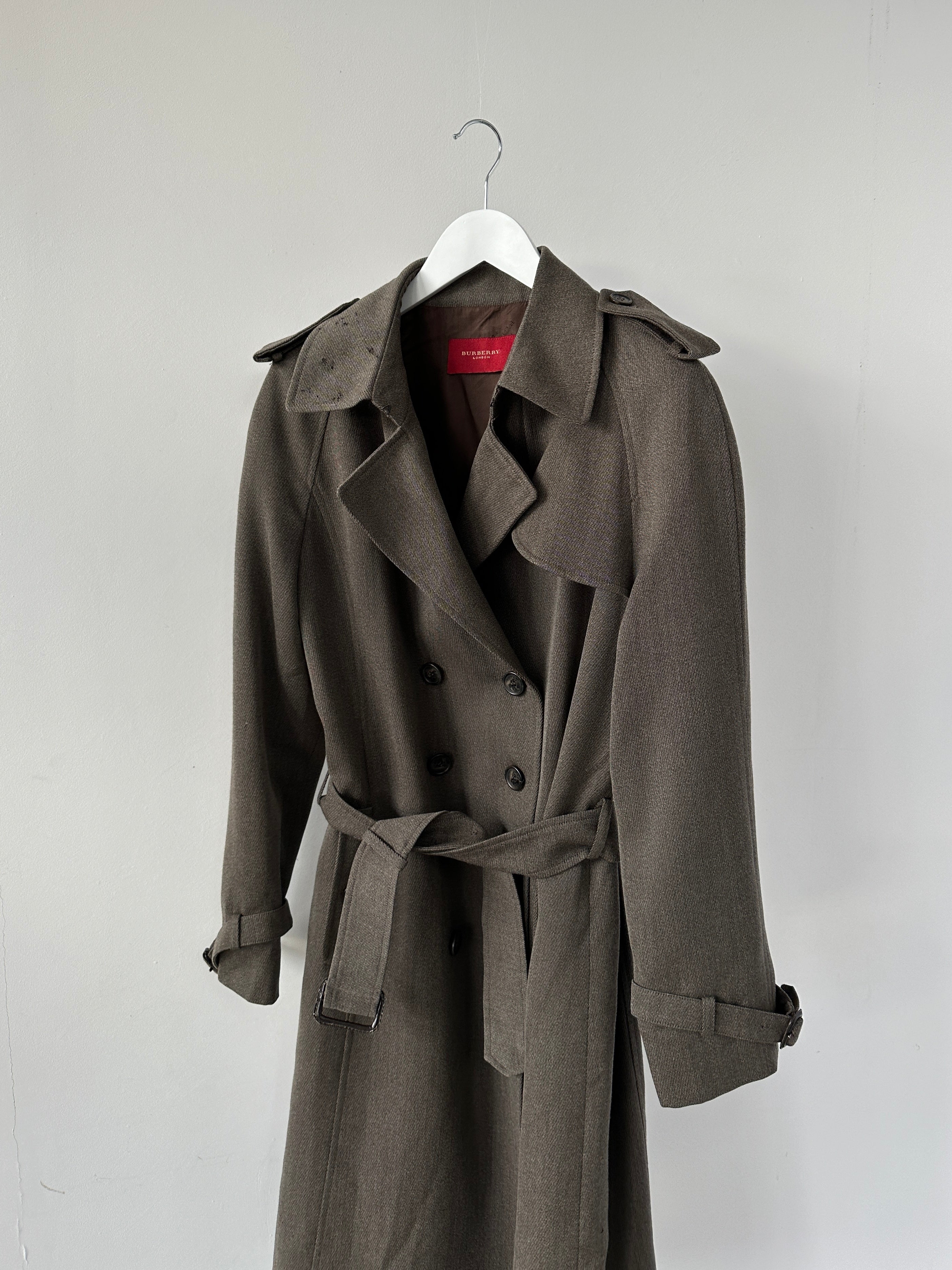 Burberry London wool double-breasted belted trench coat in beige, displayed on a hanger against a neutral background.