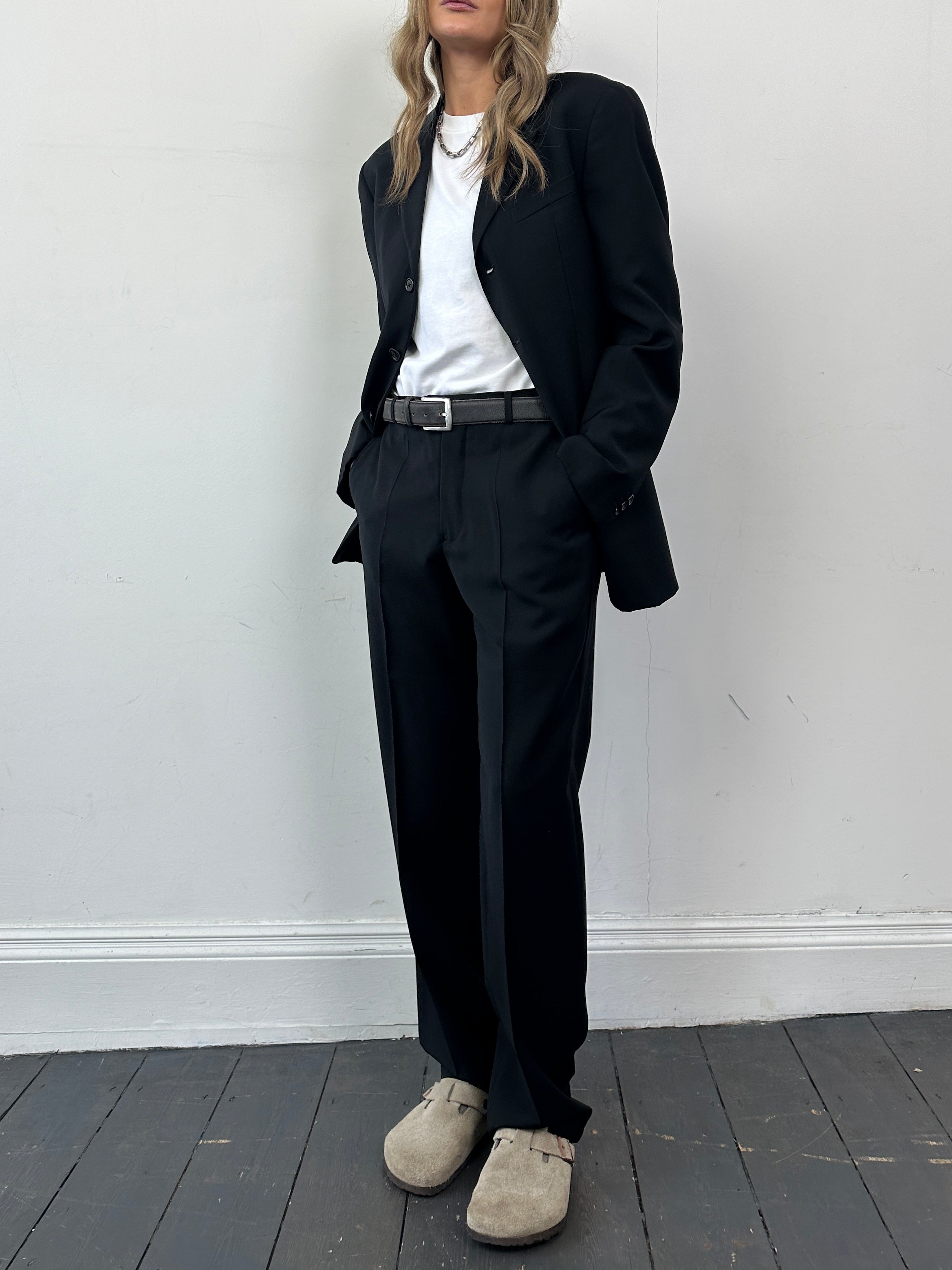 Armani Collezioni white wool single-breasted jumpsuit with lapel collar and tailored fit, displayed on a mannequin.