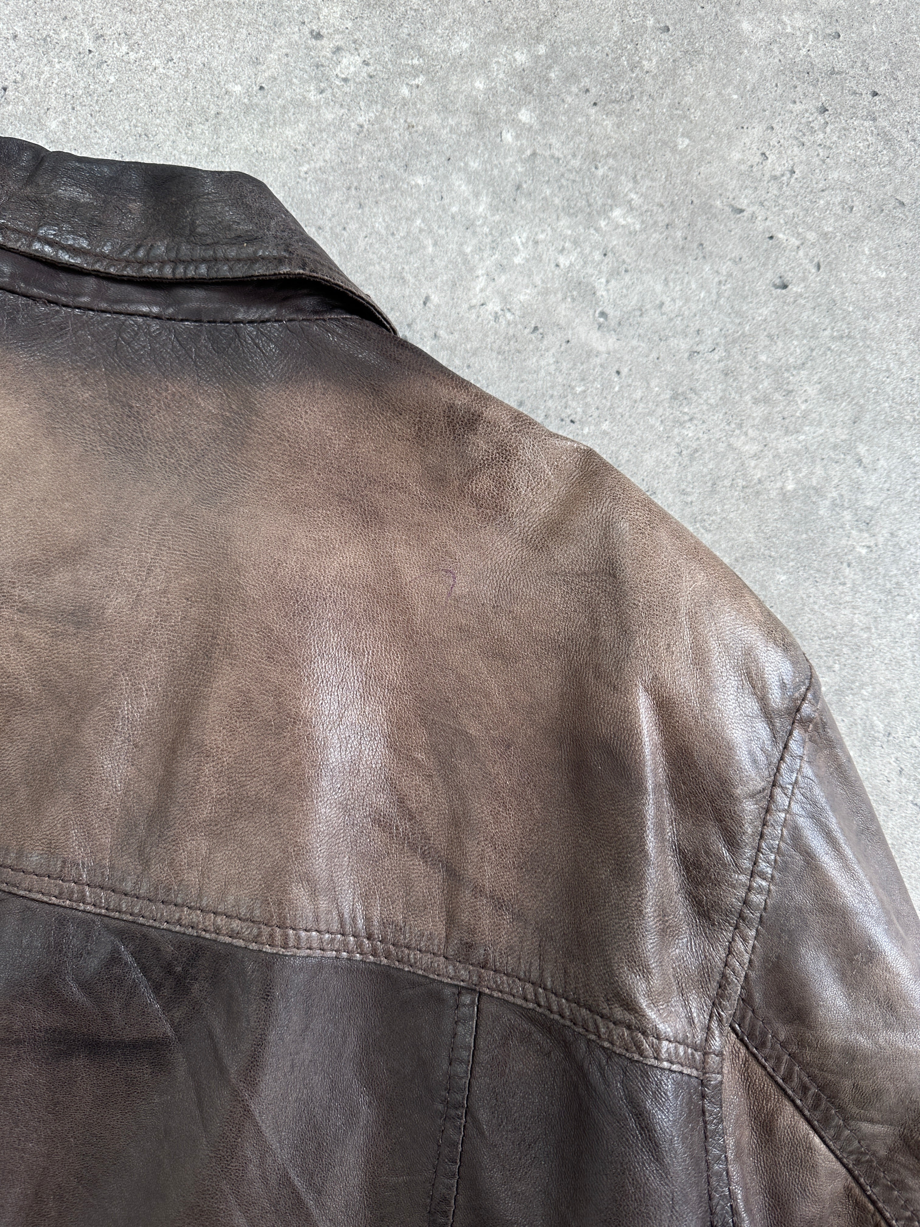 Vintage 1990s aged leather jacket in XL, showing distressed leather, classic collar, and vintage style from the Vintage brand.